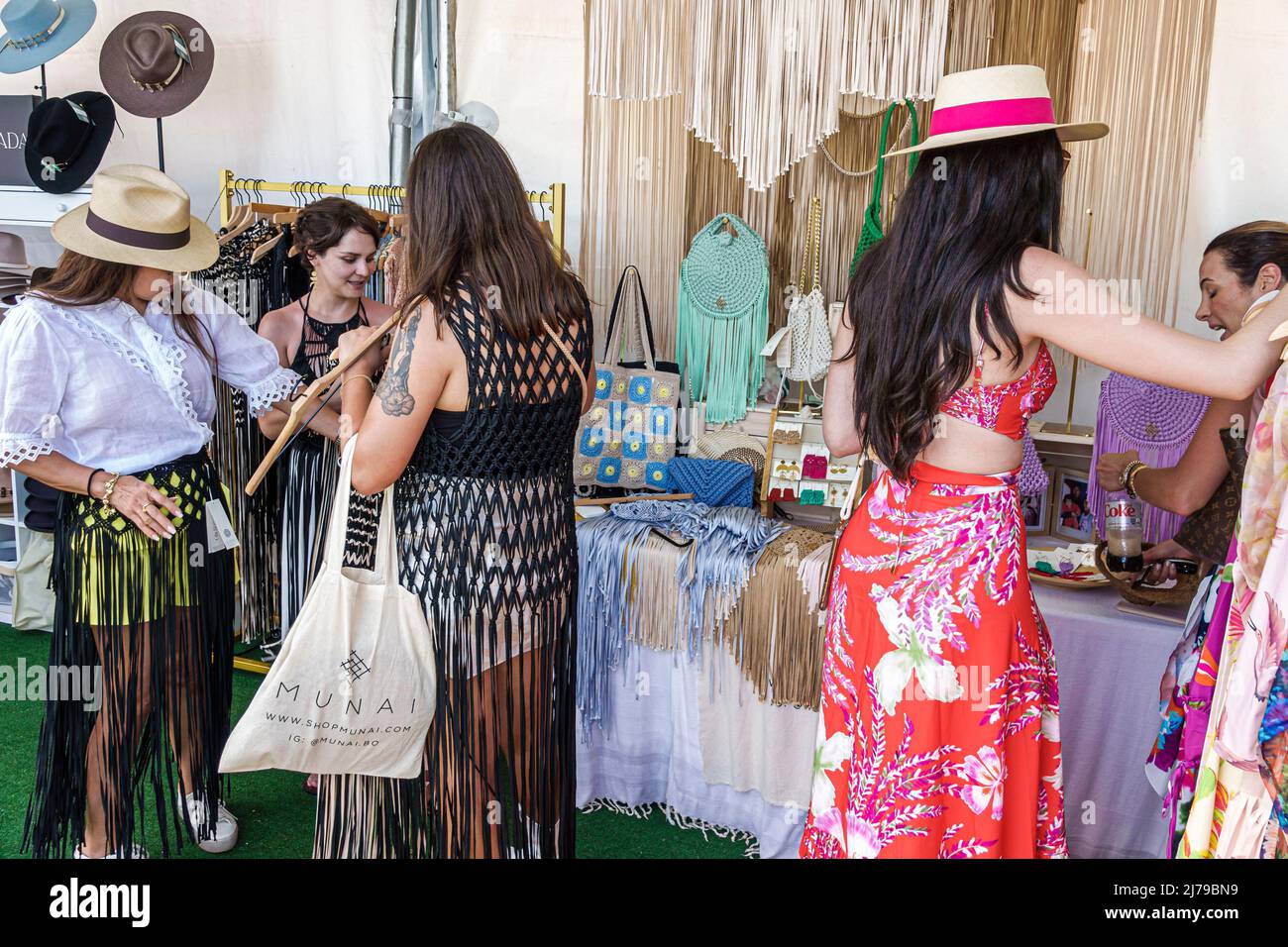 Miami Beach Florida Beach Polo World Cup Miami annual event Retail Village shopping vendors tents clothing display sale fashionable woman wearing hats Stock Photo