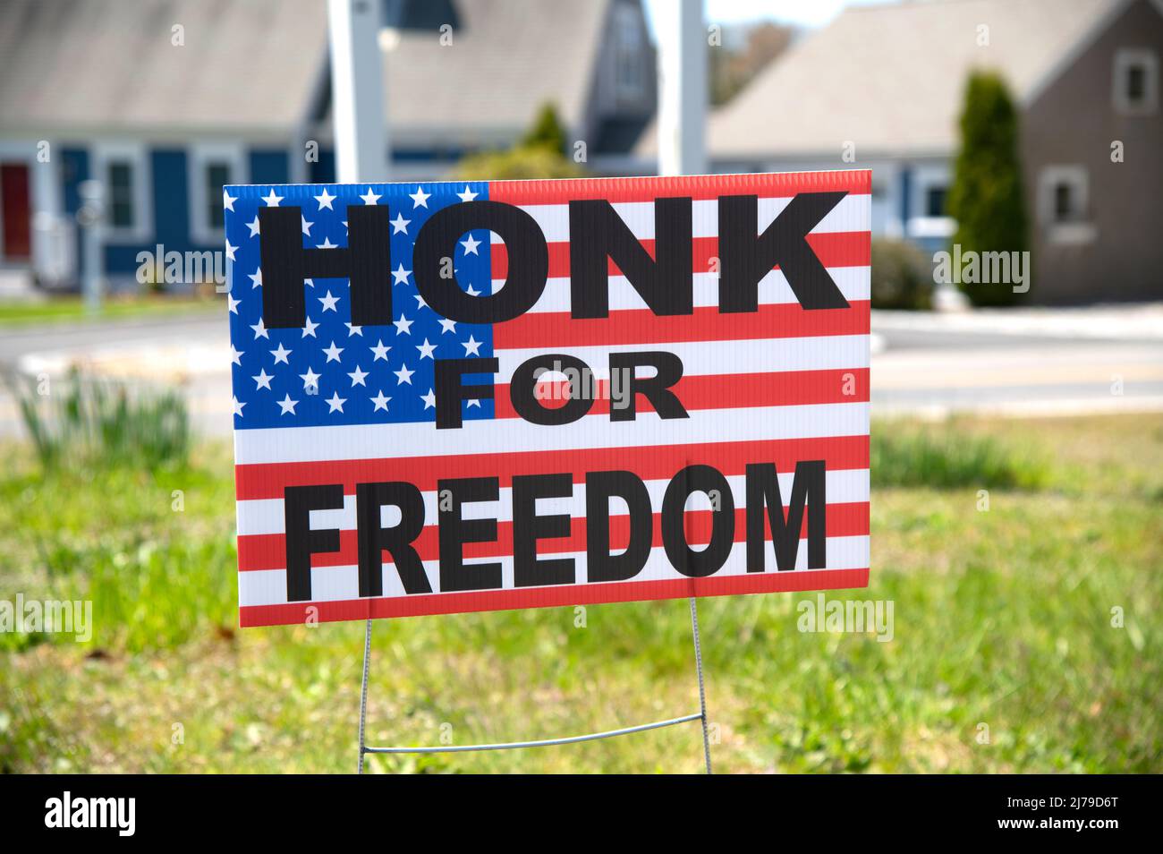 A political sign 'Honk for Freedom' along the side of a Cape Cod Road. Stock Photo