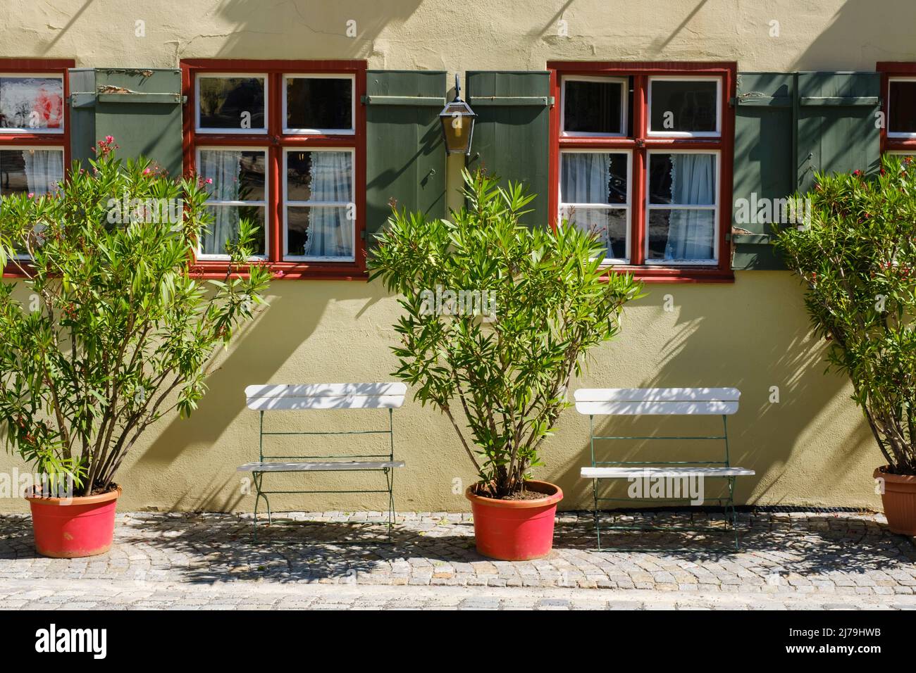 Facade of an old building with plant and chairs at the old town of Dinkelsbühl Stock Photo
