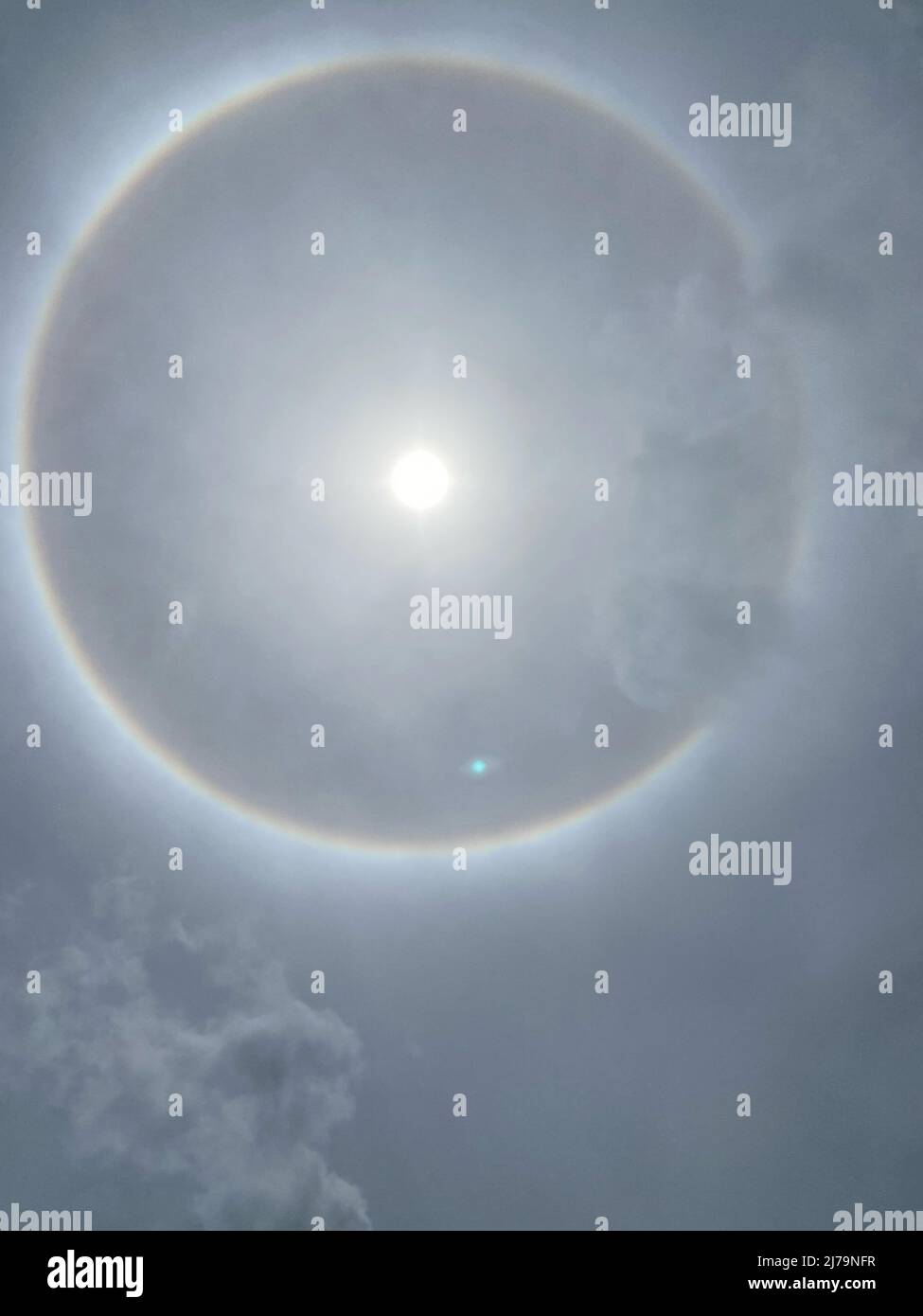 Sun halo from upper atmosphere ice - Grenada, Caribbean, mid-day May 7th 2022 Stock Photo