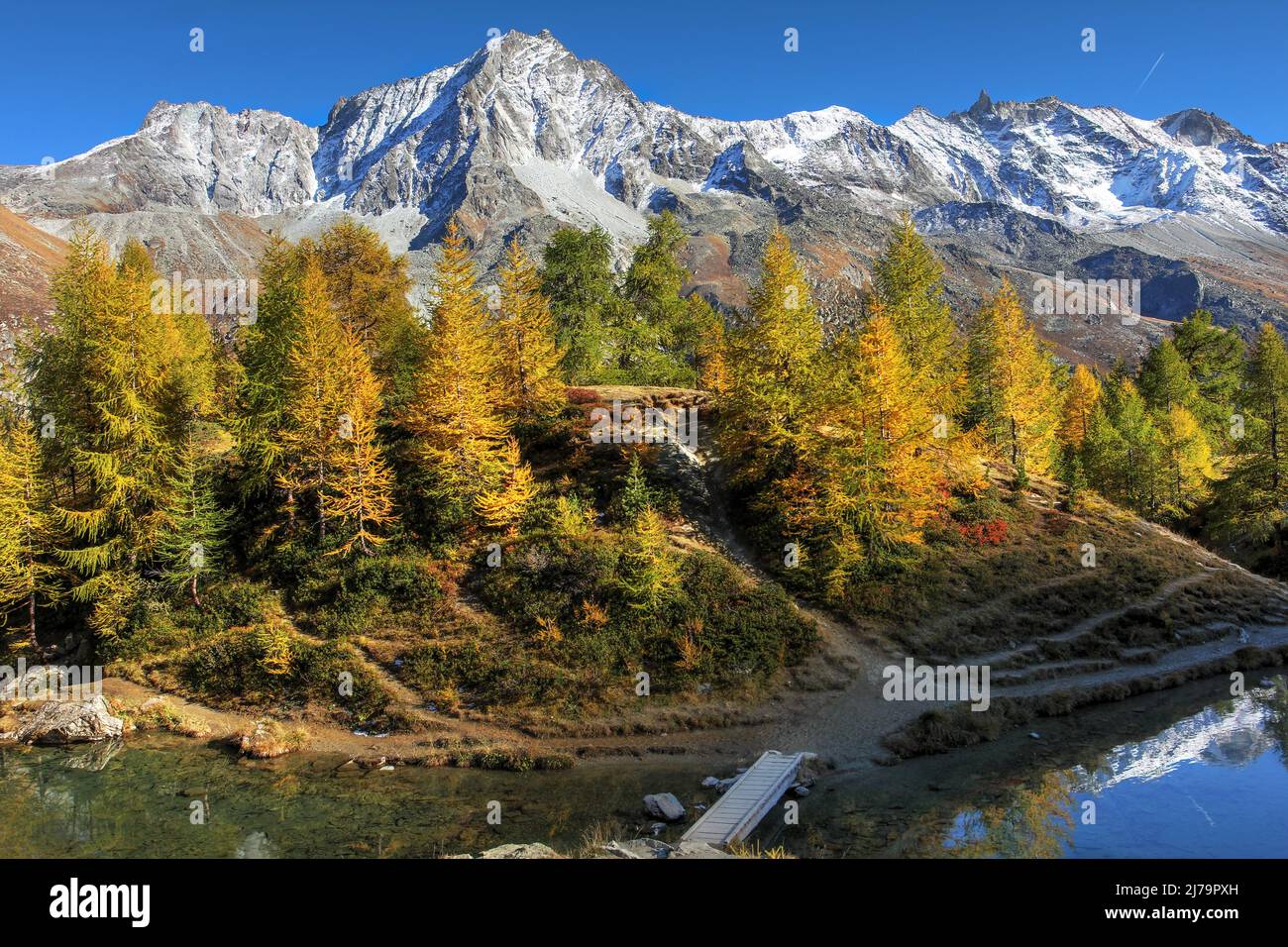 Dent du Perroc (3676m altitude) in Val d'Hérens near Sion in Valais (Wallis) canton of Switzerland as seen from the Lac Bleu in a beautiful autumn day Stock Photo