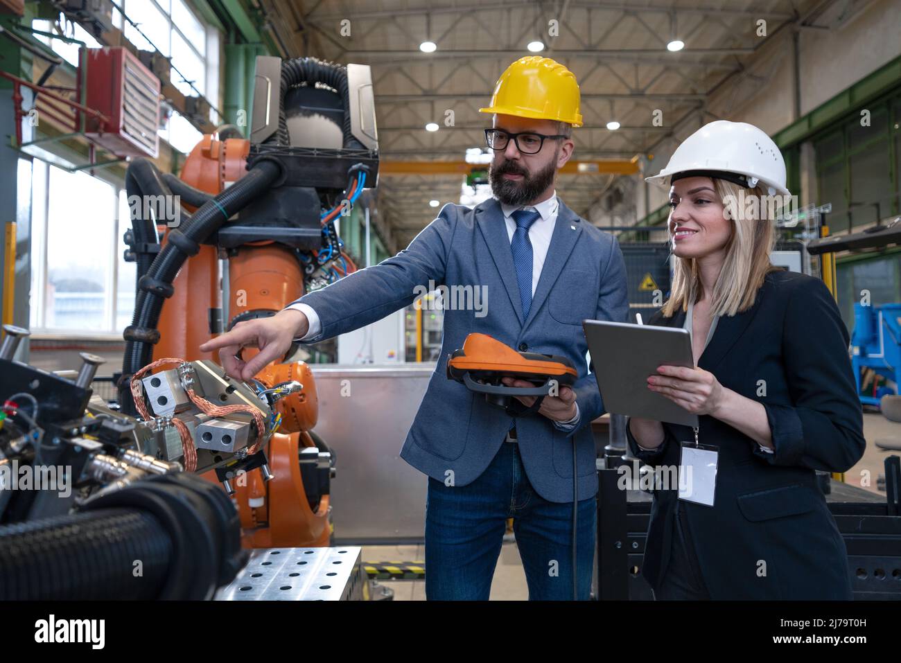 Chief engineer and project manager in modern industrial factory with