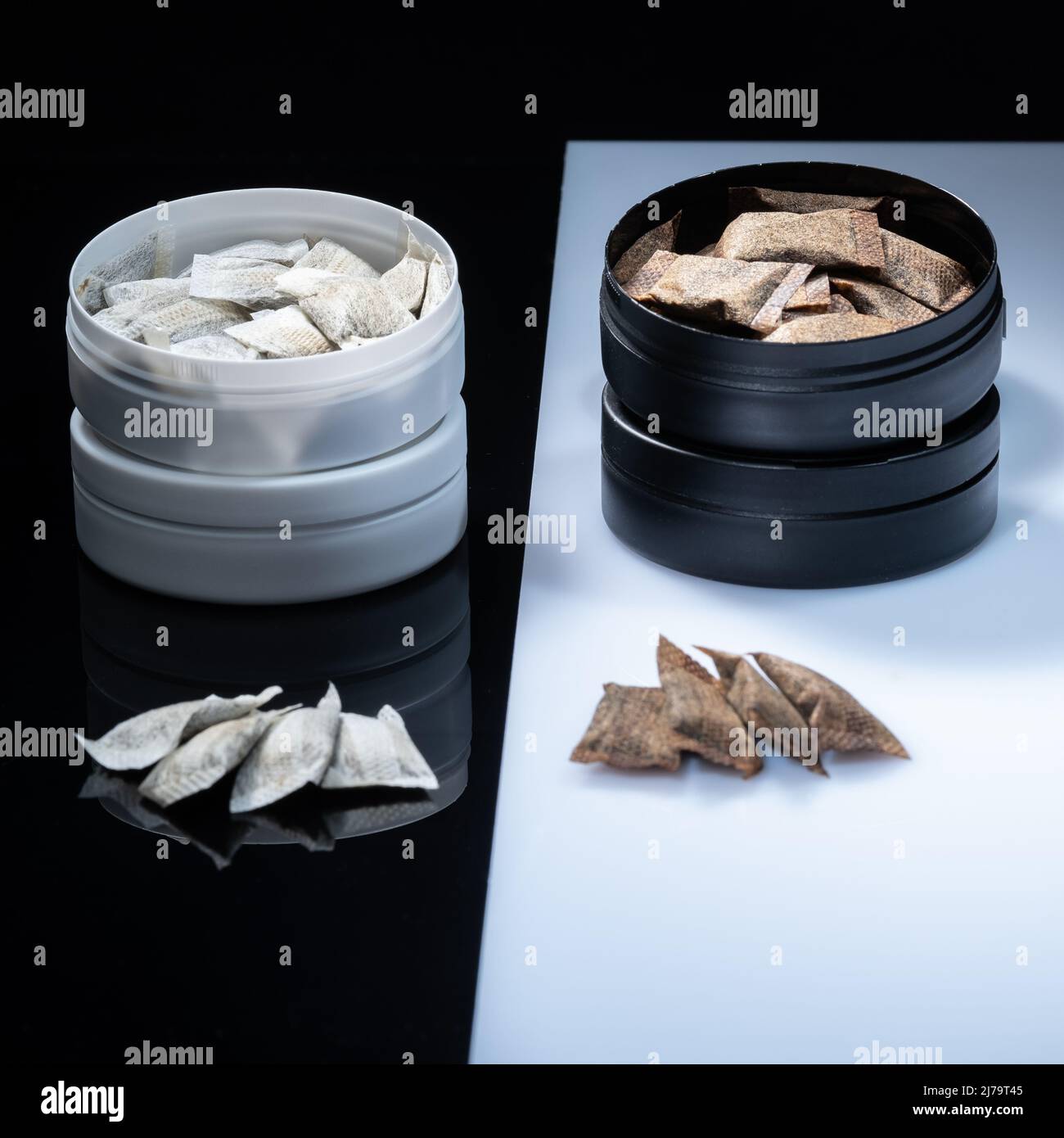 Closeup of two Swedish smokeless tobacco products. Snus cans with white and regular portion snuff Stock Photo