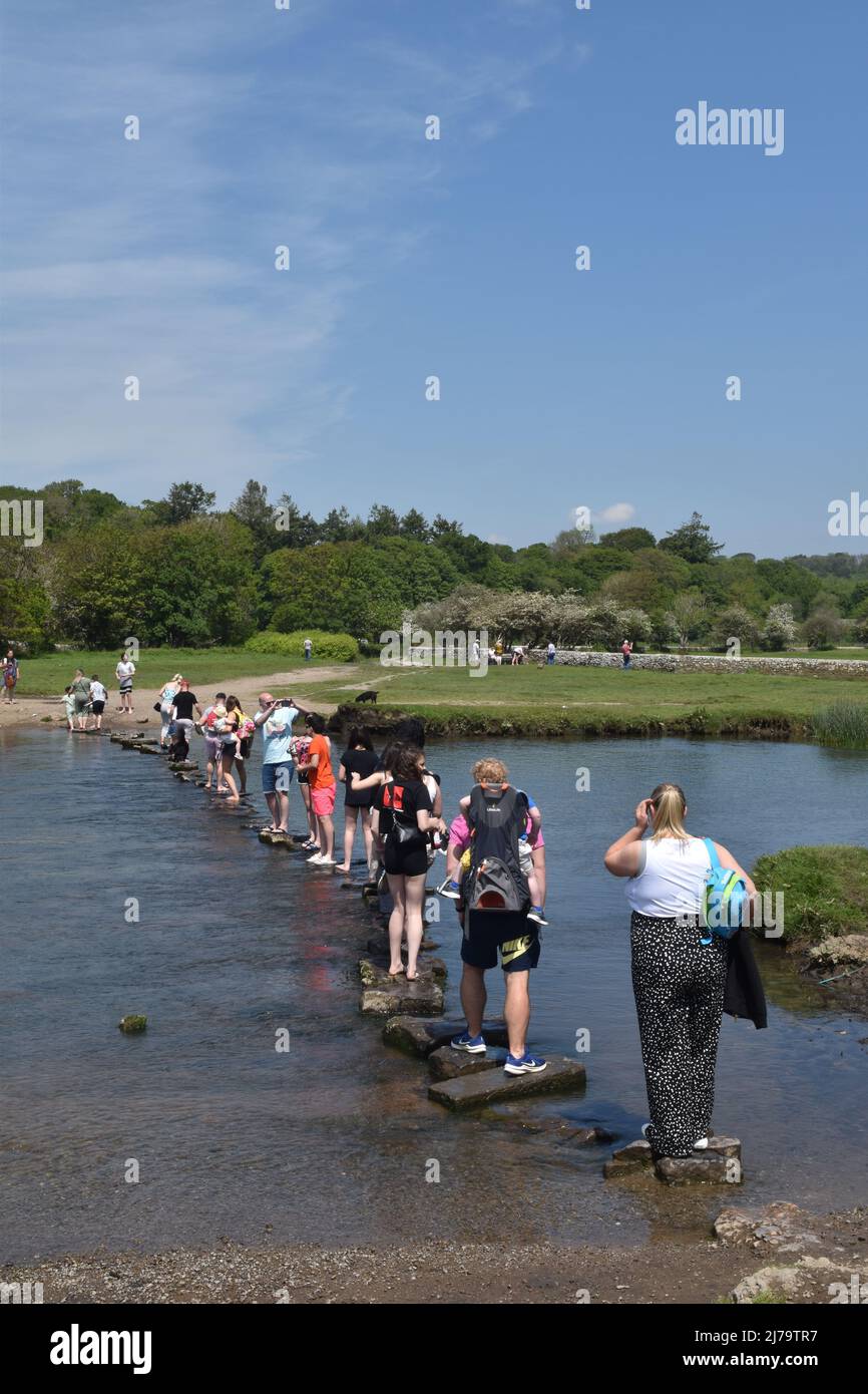 Crossing the Ogmore River on Stepping Stones, near Ogmore On Sea, Glamorgan Stock Photo