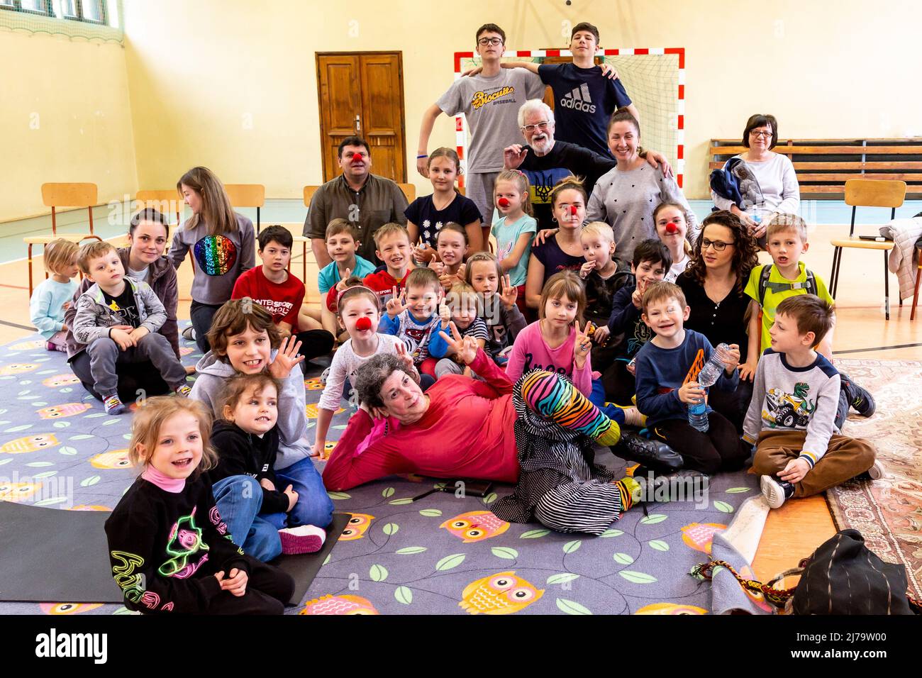 American magicians of Magician Without Borders, Tom Verner and Janet Fredericks pose with Ukrainian refugee children after their show at a humanitarian help centre in Korzkiew near Krakow. More than 3 million people have already fled Ukraine for Poland. Since the Russian Federation invaded Ukraine, the conflict forced 5.6 million Ukrainians to flee their country. The Polish population welcomed the refugees, offering their own homes as accommodation, Many individuals and NGOs provide humanitarian help. Stock Photo