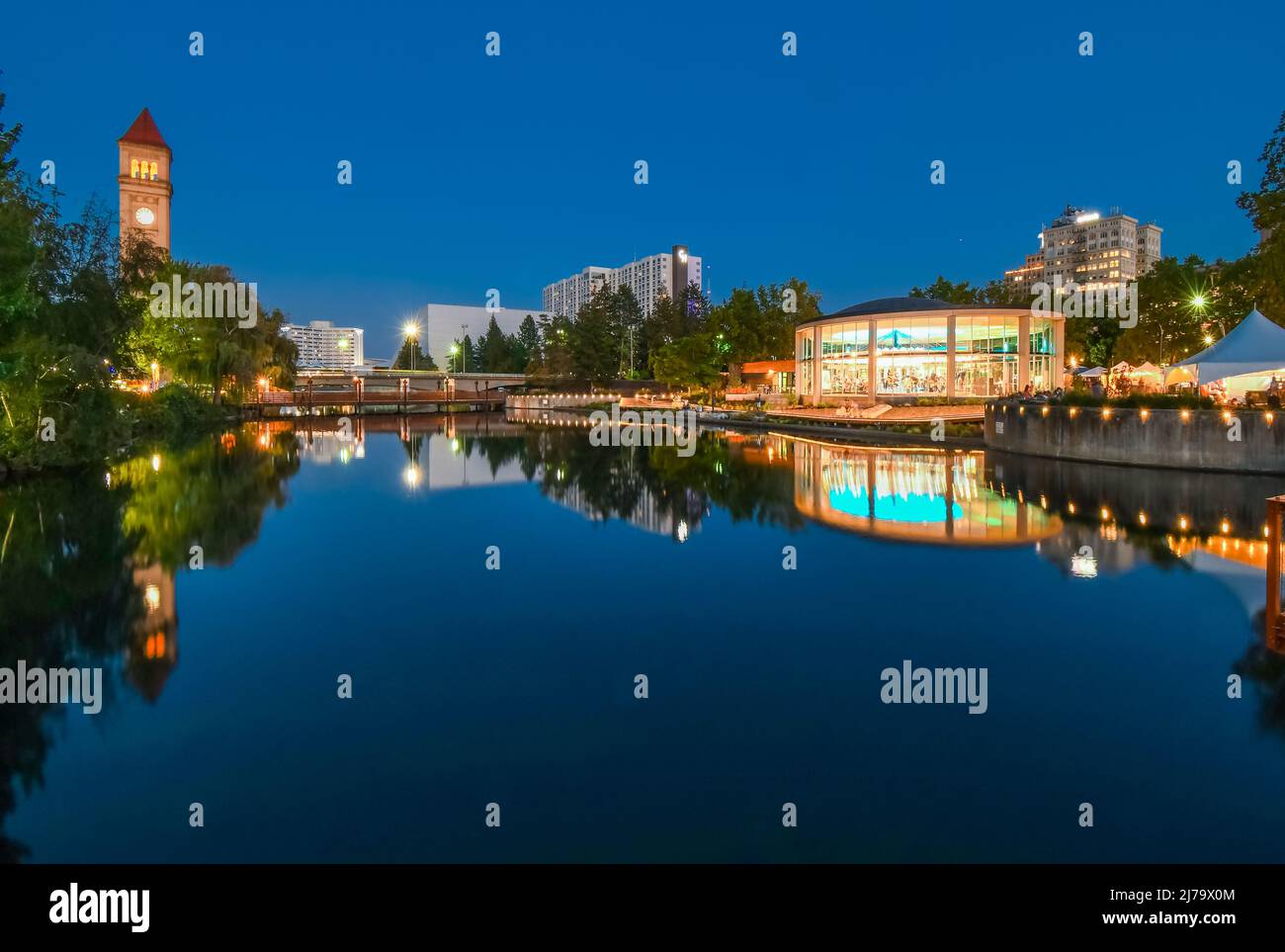 The Clock Tower illuminated next to the Spokane River in the Riverfront Park area of downtown Spokane, Washington, USA late at night. Stock Photo