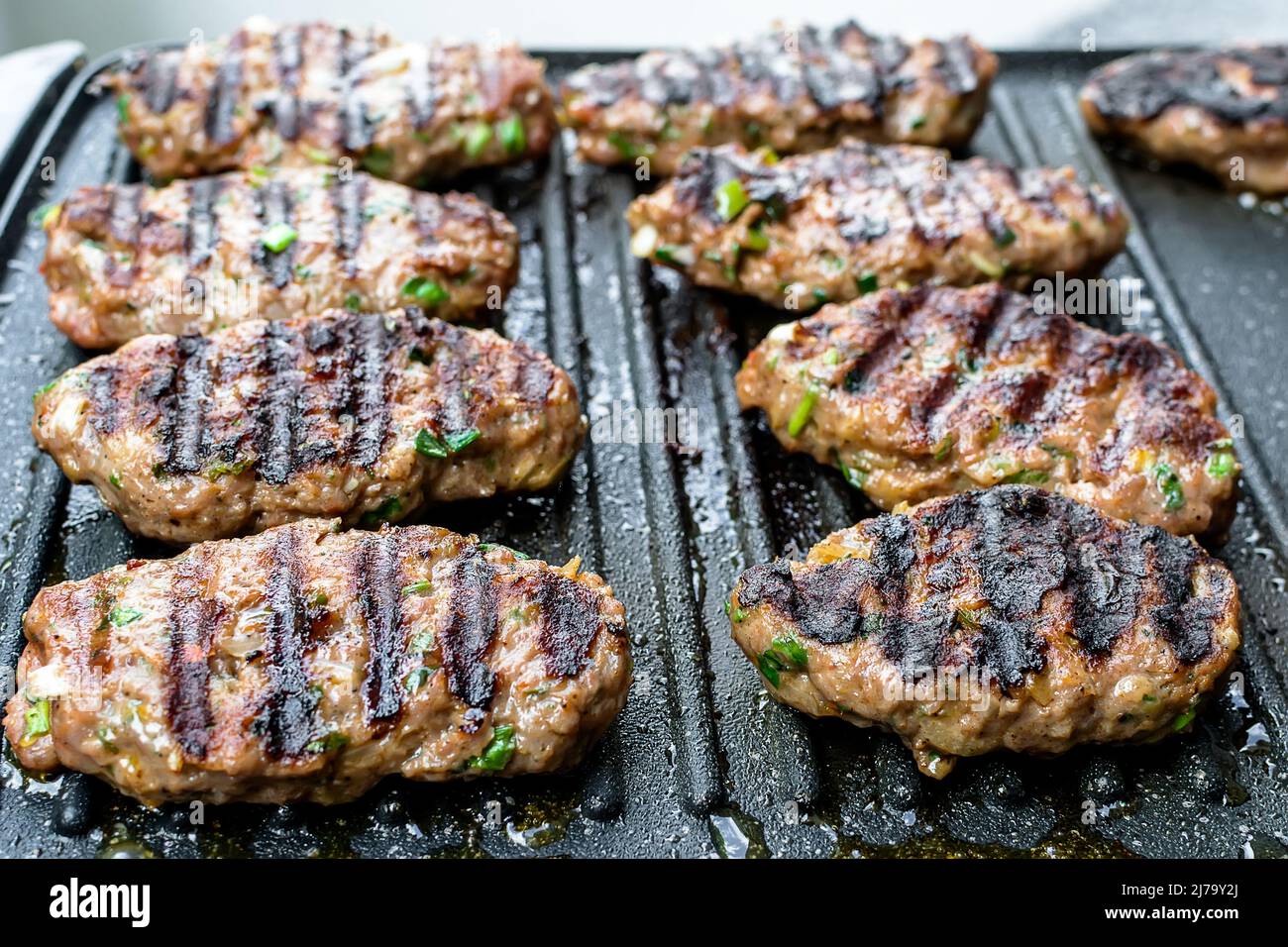 Juicy lamb meatballs on teflon barbecue grill Stock Photo Alamy