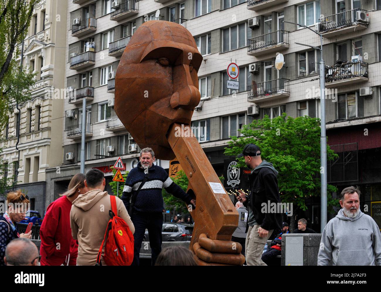 People take pictures next to the sculpture depicting the President of