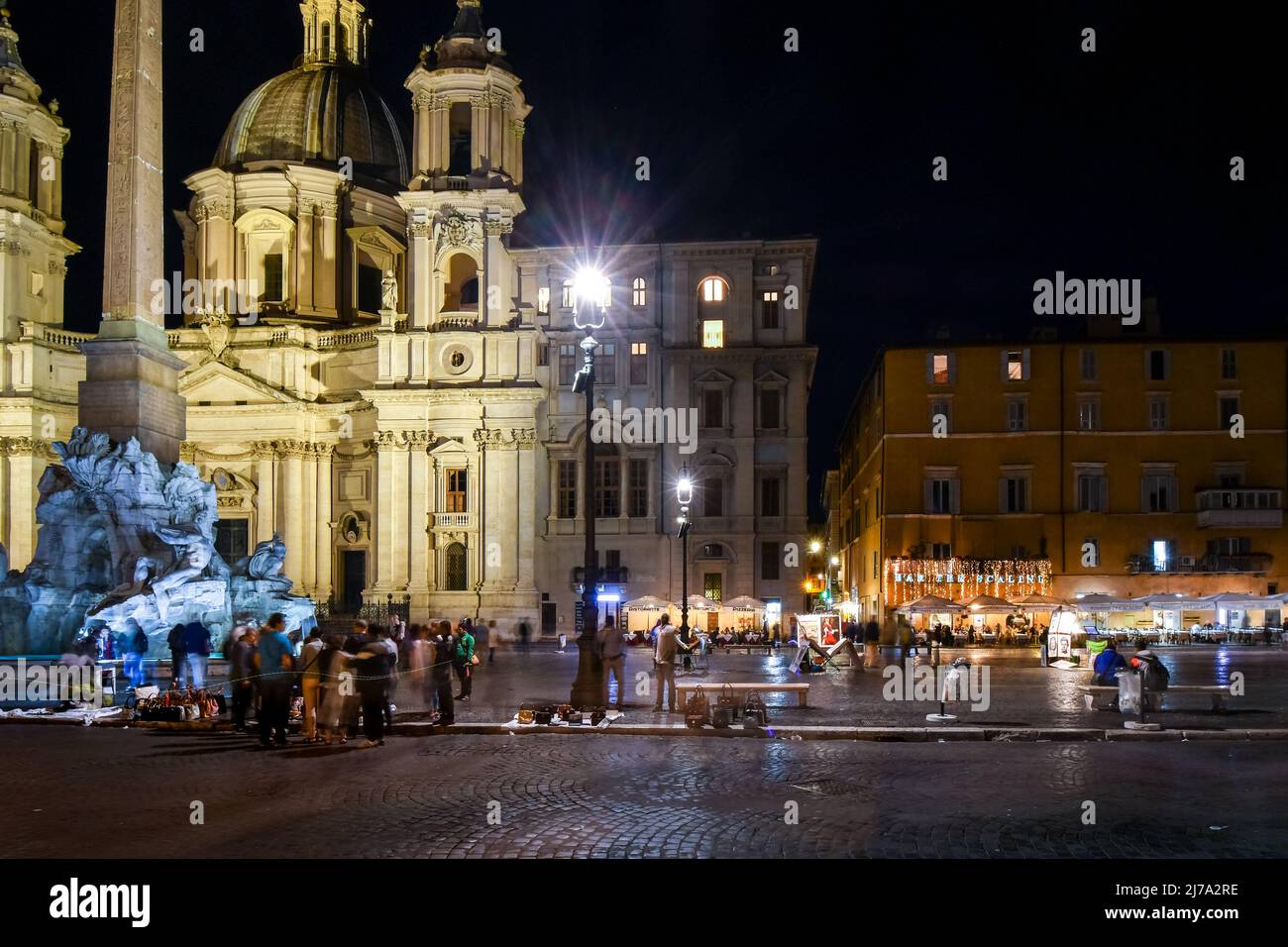 Night view of Piazza Navona with illuminated cafes, the Sant'Agnese in Agone Church and Fountain of the Four Rivers in Rome, Italy. Stock Photo