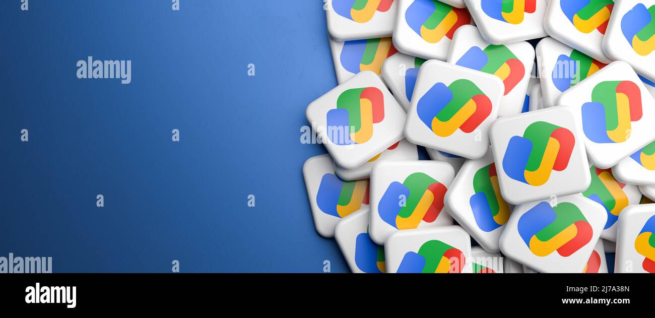 Logos of the Google Pay (Google Wallet plus Android Pay) service on a heap on a table. Copy space. Web banner format. Stock Photo