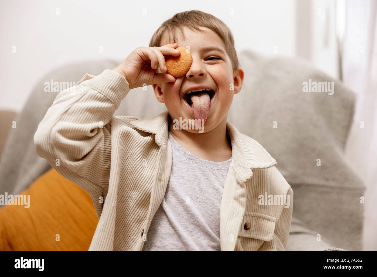 Portrait of little adorable boy holding biscuit. Kid with cookie. Child and gluten. Healthcare, gluten intolerance by kids. Preschool child with Stock Photo