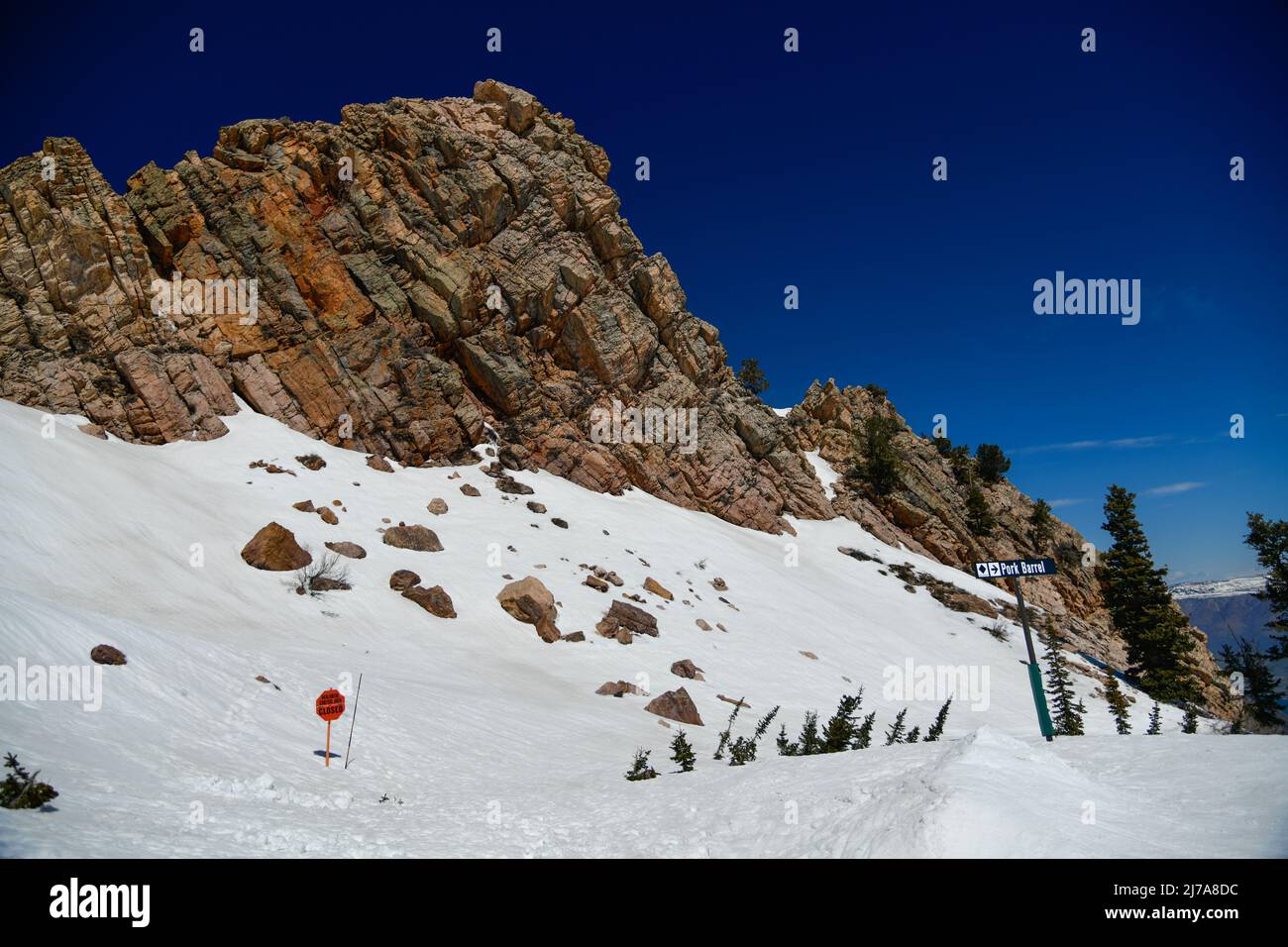 Beautiful landscape at Snowbasin Ski Resort, Utah. Snow slopes, rocky mountains and trees on a sunny day. Stock Photo
