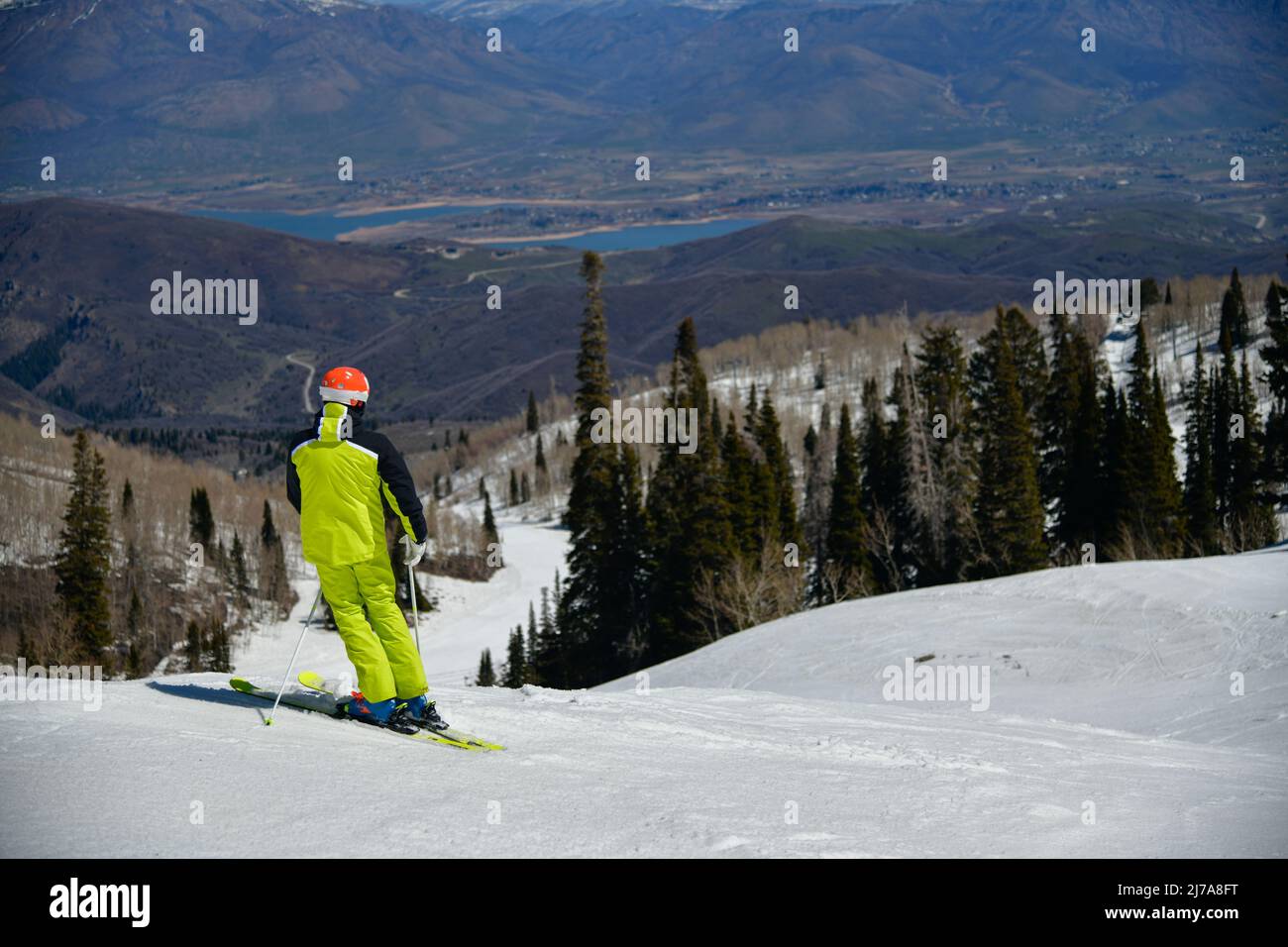Skiing downhill on a beautiful sunny day at Snowbasin Ski Resort, Utah