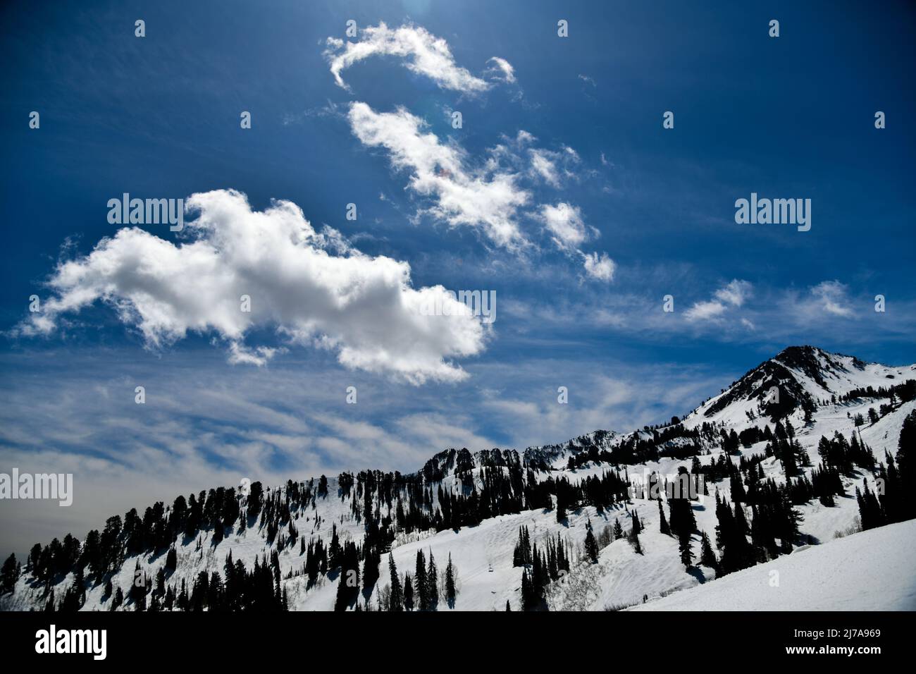 Early spring season at Snowbasin Ski Resort in Utah. Snow slopes on a sunny day. Stock Photo