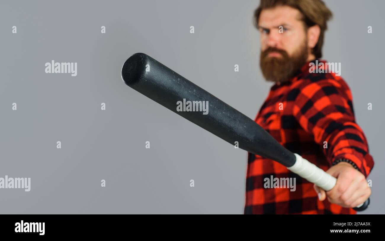 Male player with baseball bat. Sports equipment advertising. Baseball sport concept. Selective focus. Stock Photo