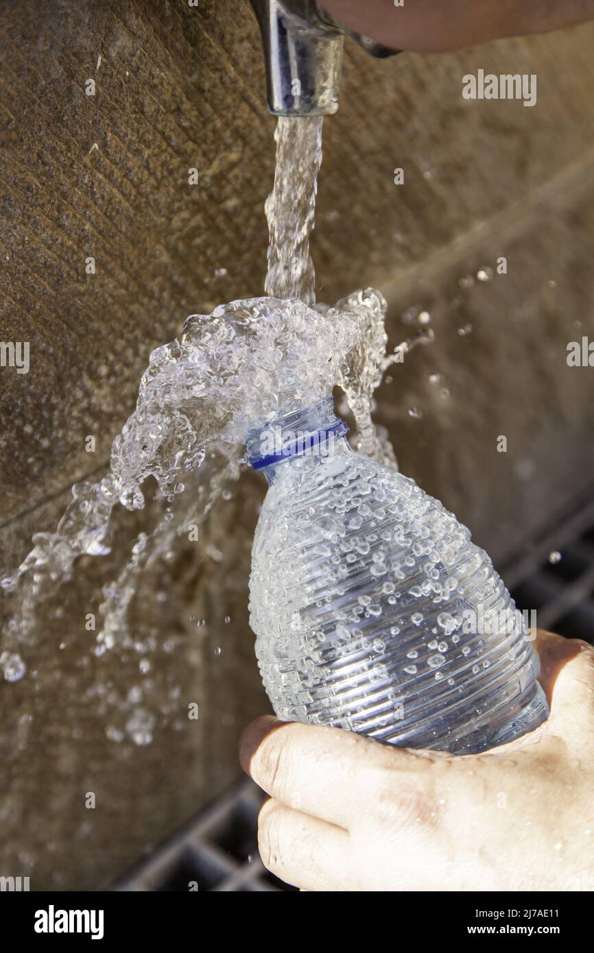 Filling water bottle in fountain, water and summer, refreshment Stock Photo