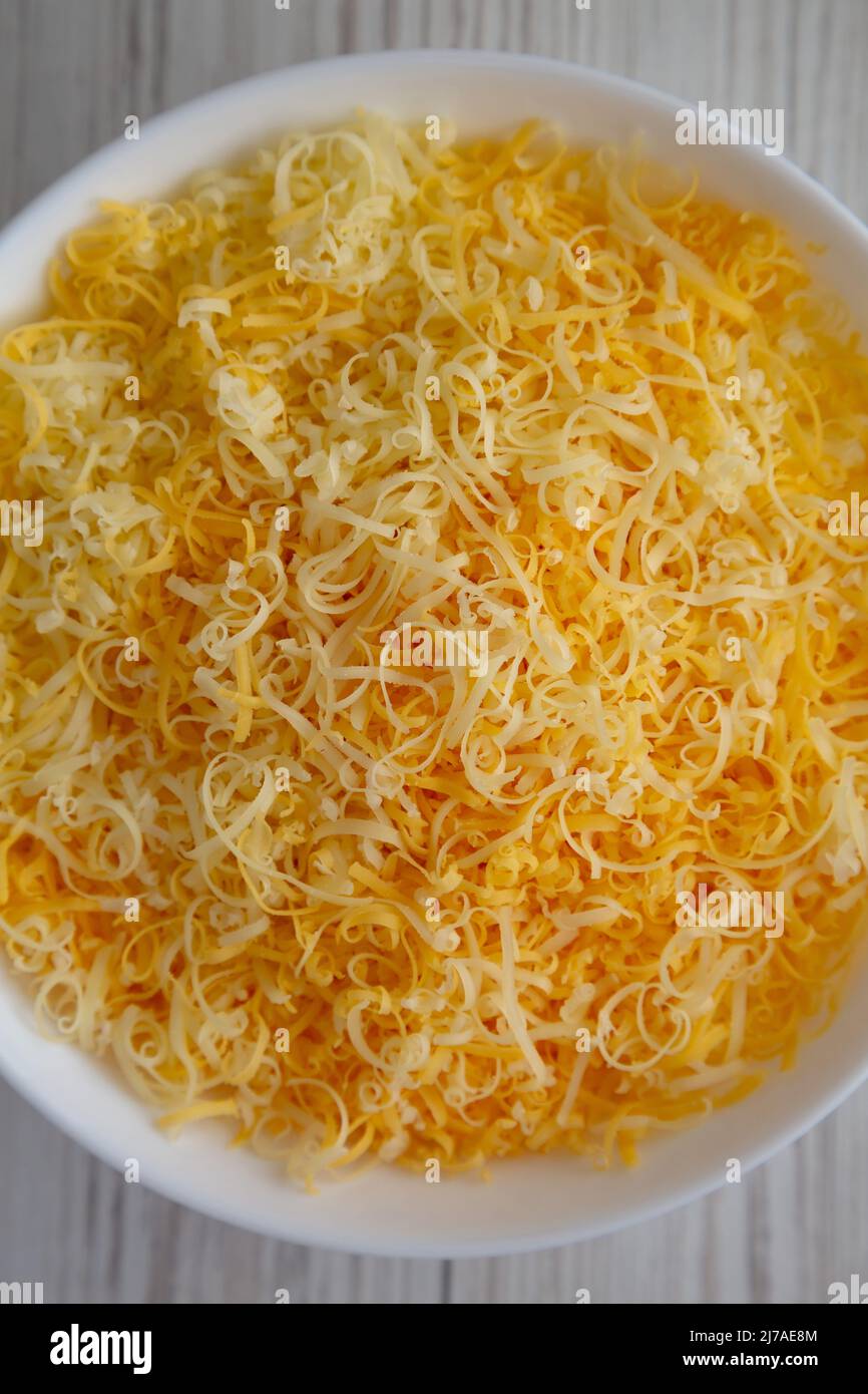 Shredded Mexican Cheese Mix in a White Bowl, top view. Flat lay