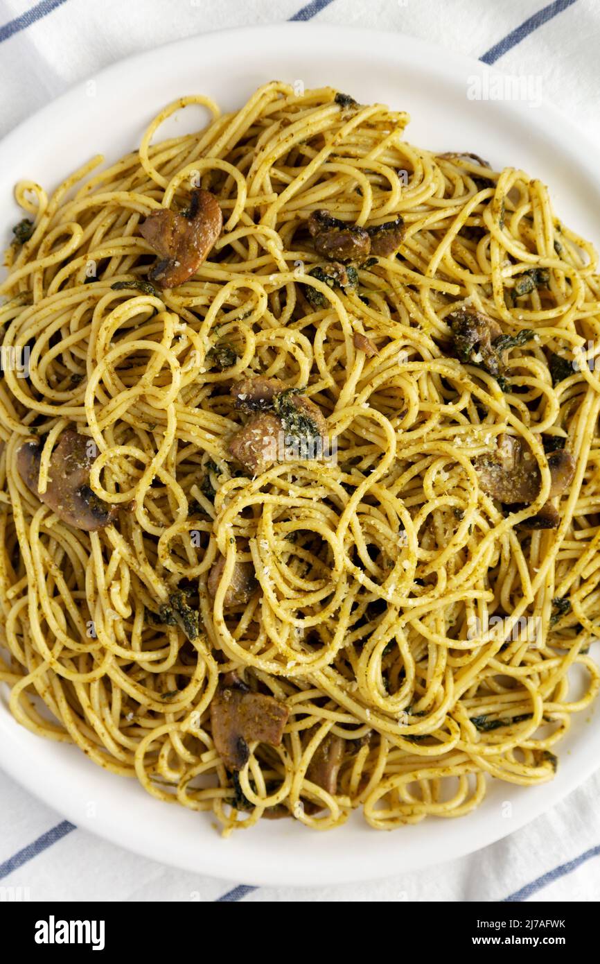 Homemade Spinach Mushroom Pesto Spaghetti on a Plate, top view. Flat
