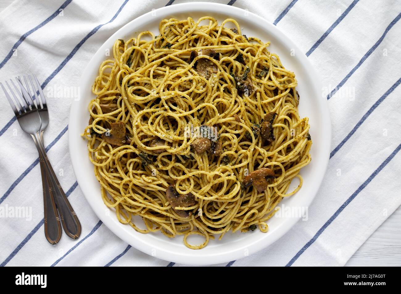 Homemade Spinach Mushroom Pesto Spaghetti on a Plate, top view. Flat