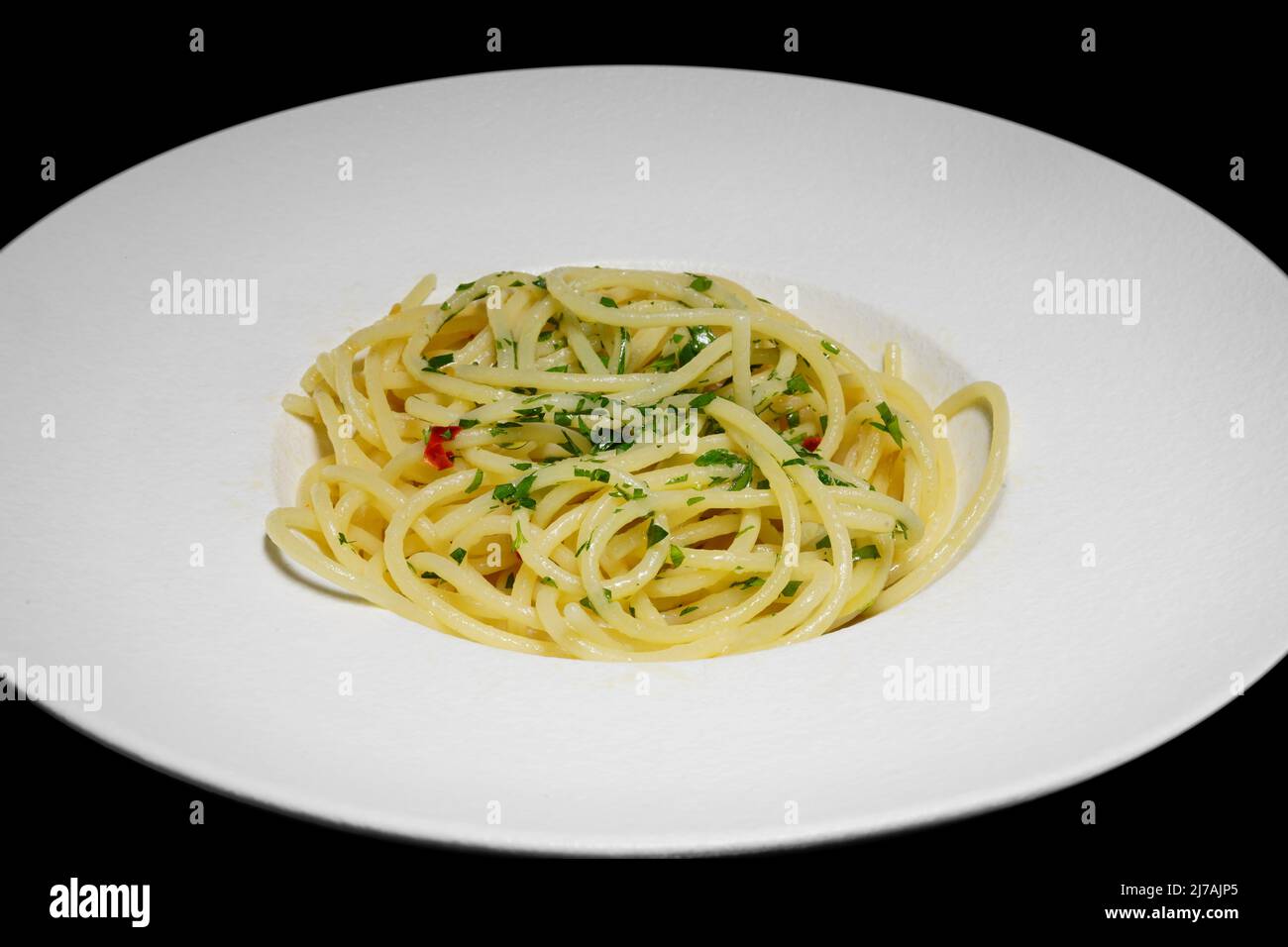 Spaghetti with garlic, olive oil, parsley and red pepper (italian: spaghetti aglio olio e peperoncino); is a traditional italian dish. Stock Photo