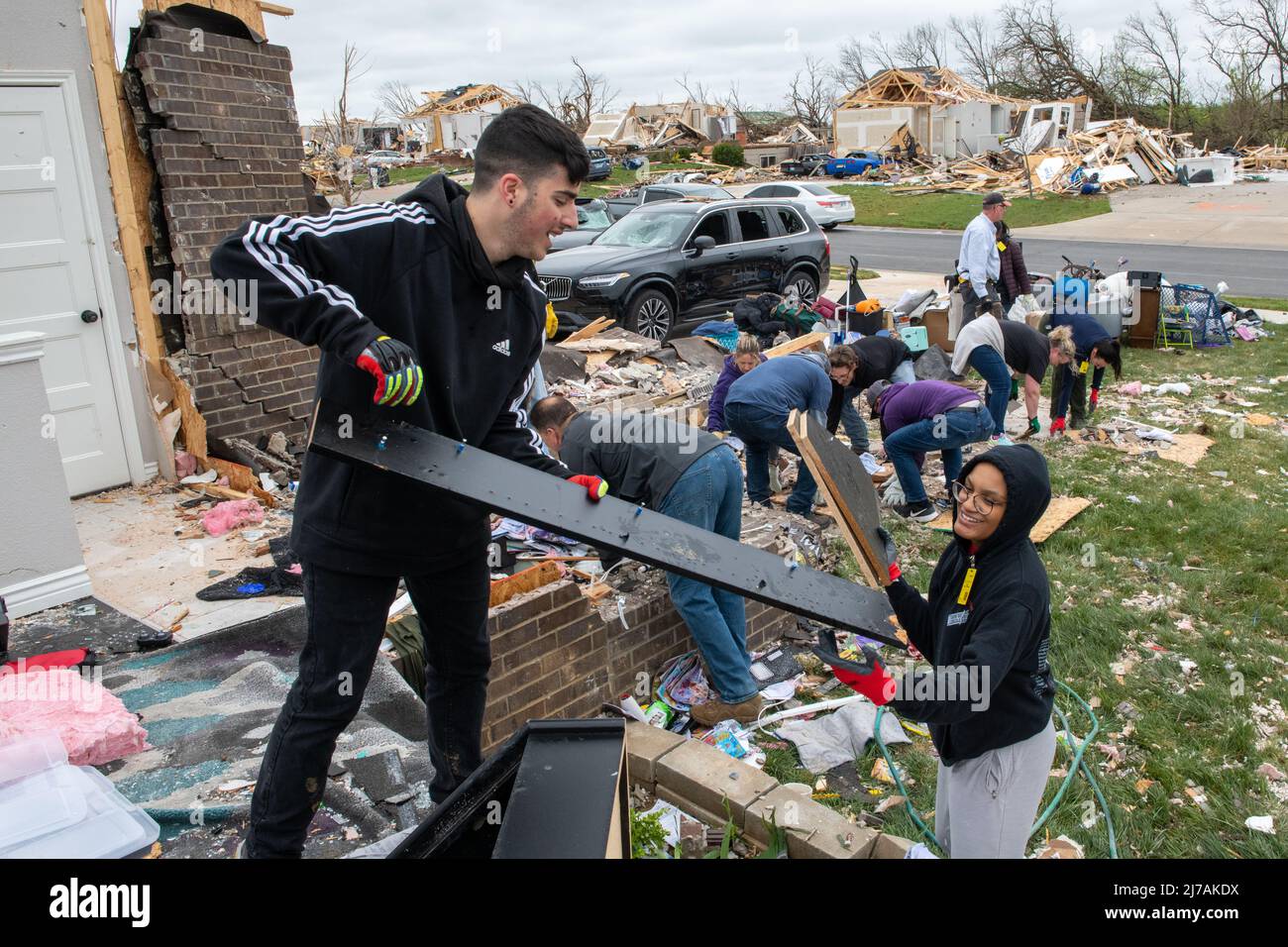 Andover, United States of America. 29 April, 2022. U.S. Air Force airmen work alongside residents to clean up damaged homes in the aftermath of an EF-3 tornado, April 29, 2022, in Andover, Kansas. The tornado damaged hundreds of buildings in the Wichita suburb.  Credit: SSgt. Adam Goodly/U.S. Air Force Photo/Alamy Live News Stock Photo