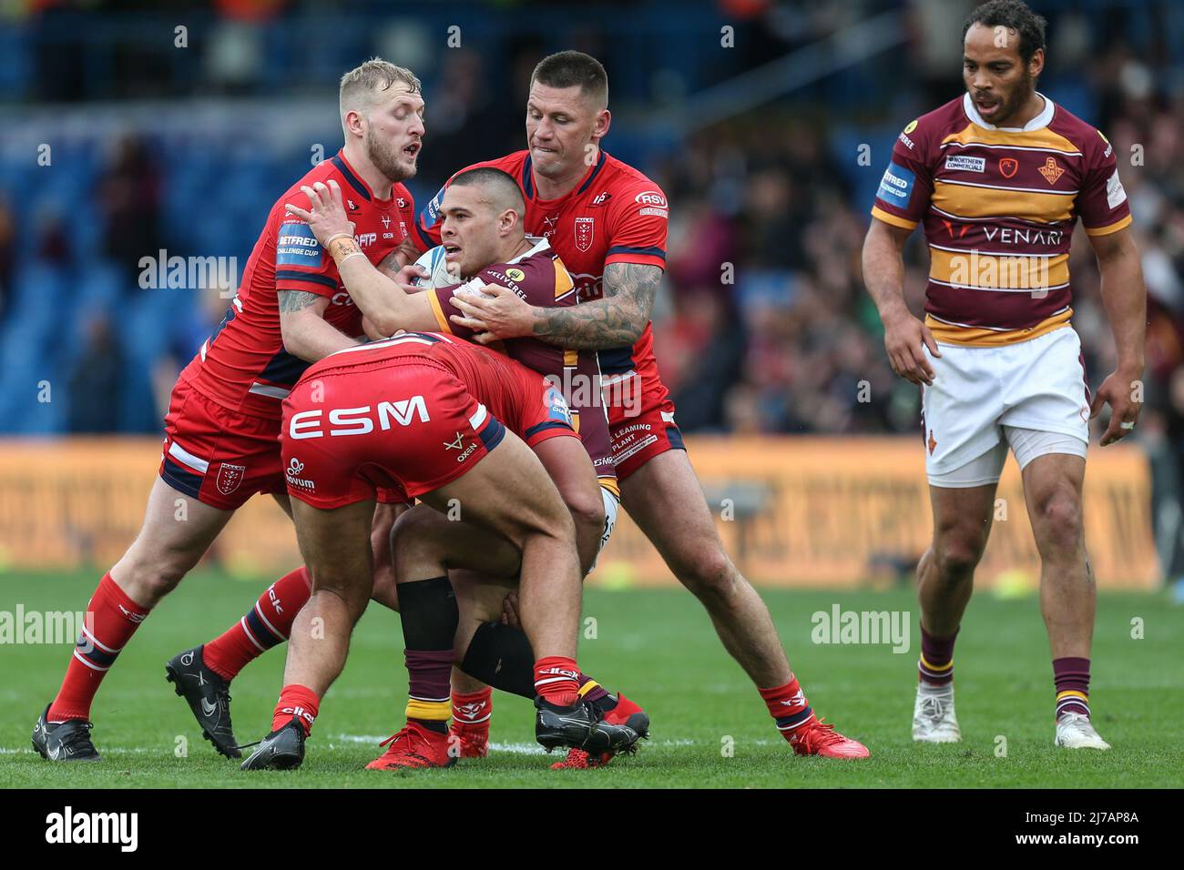 Tui Lolohea #6 of Huddersfield Giants is stopped by the Hull KR defence ...