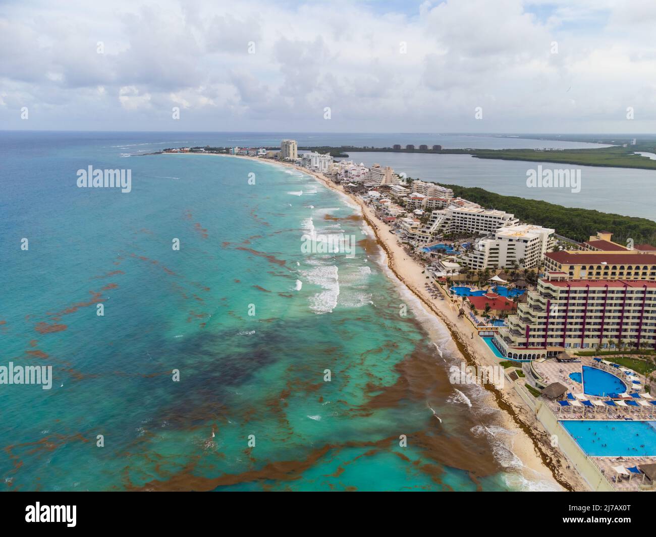 Aerial view. Resort town, sandy beach. The sea near the shore is polluted with seaweed. The concept is environmental protection, ecology, climate chan Stock Photo