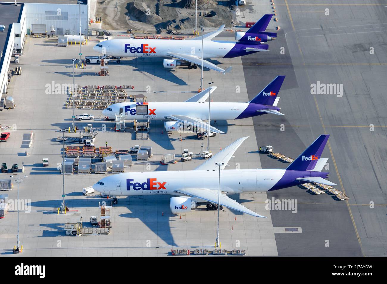 Aircraft of FedEx Cargo at Anchorage Airport, a hub for freight transportation for Federal Express. Line up of freighter airplanes. Stock Photo