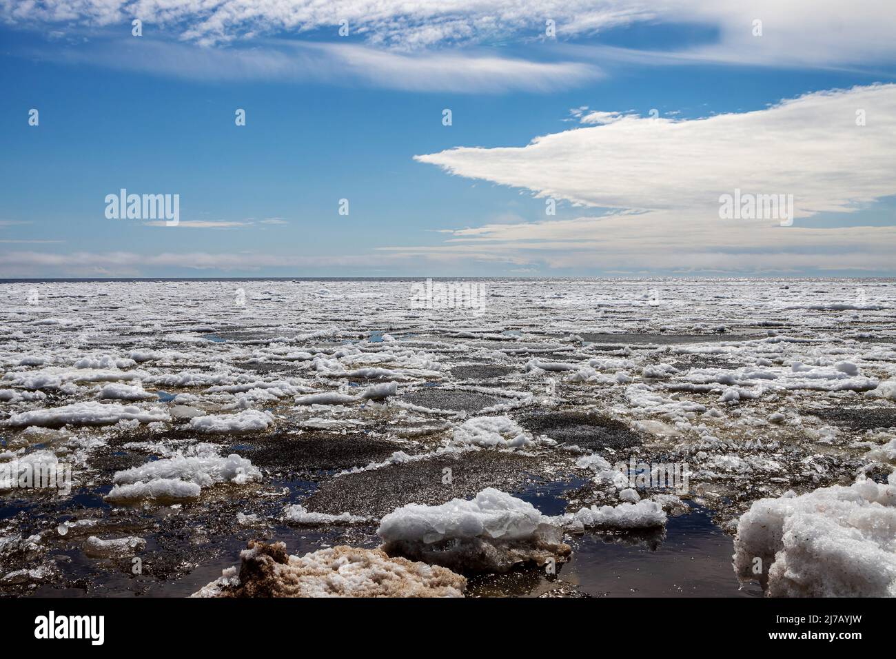 Lake Ladoga covered with ice in front of the icebreaker. The sky with