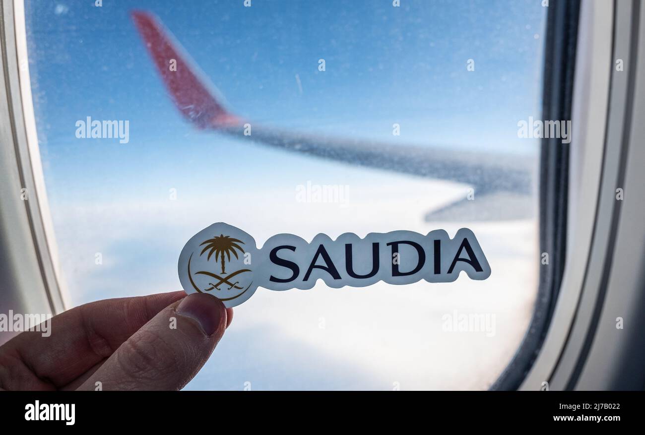 December 6, 2021, Jeddah, Saudi Arabia. The emblem of the airline Saudia on the background of the window of the aircraft. Stock Photo