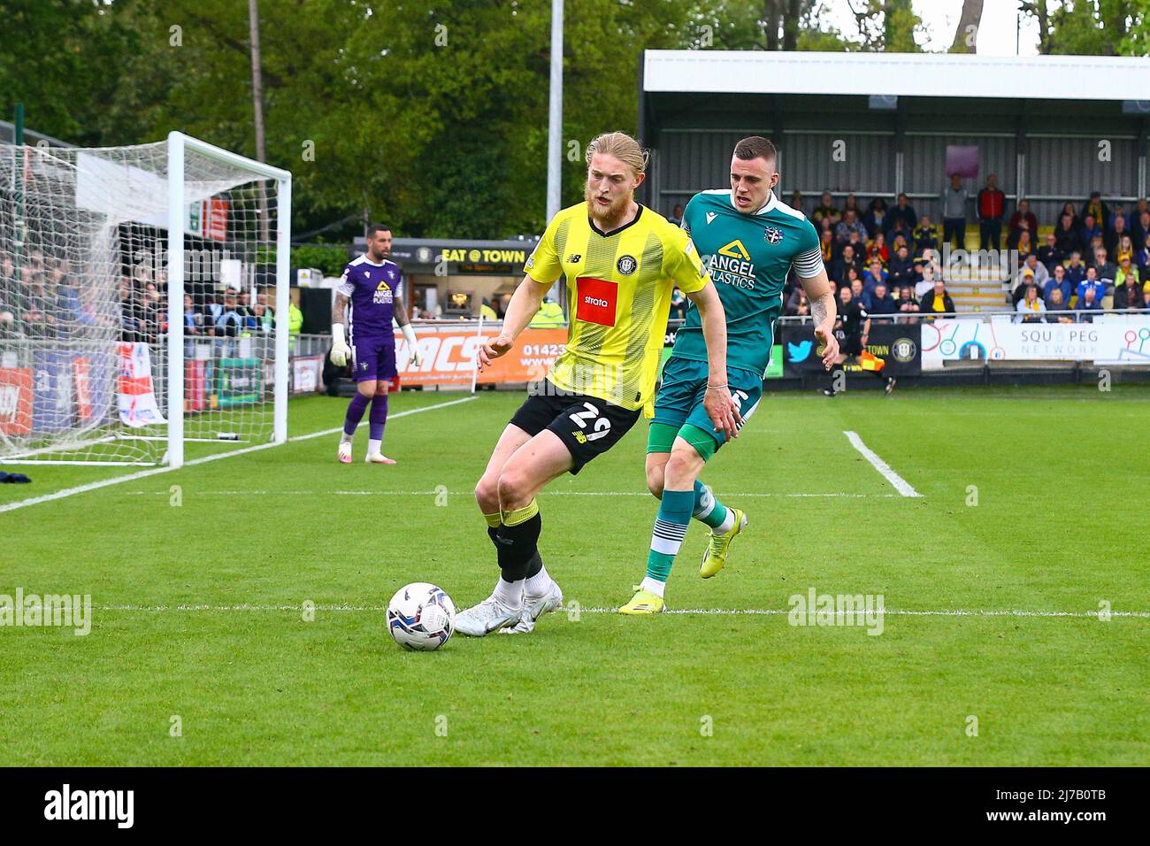 The EnviroVent Stadium, Harrogate, England - 7th May 2022 Luke Armstrong (29) of Harrogate shields the ball from Ben Goodliffe (5) of Sutton United - during the game Harrogate v Sutton, EFL League 2, 2021/22, at The EnviroVent Stadium, Harrogate, England - 7th May 2022  Credit: Arthur Haigh/WhiteRosePhotos/Alamy Live News Stock Photo