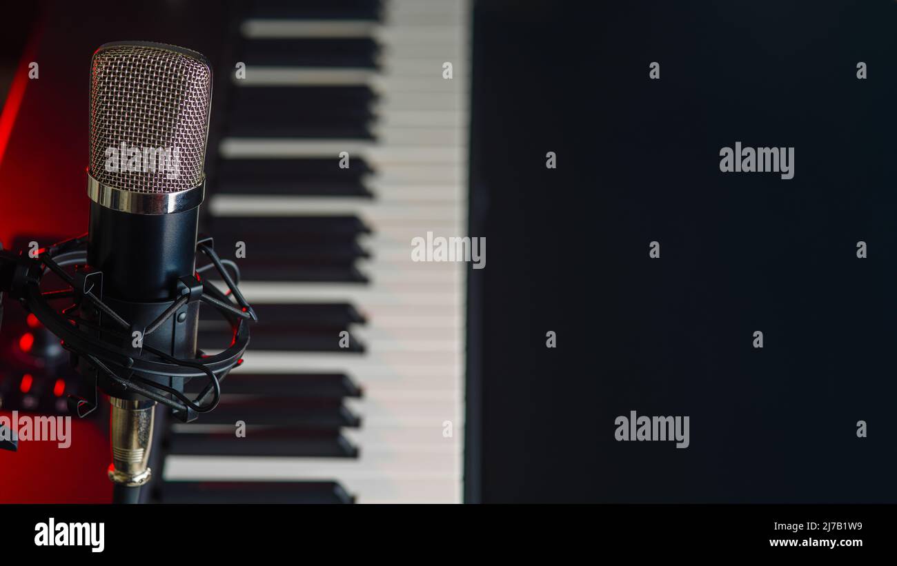 Closeup. MIDI keyboard, synthesizer and professional microphone