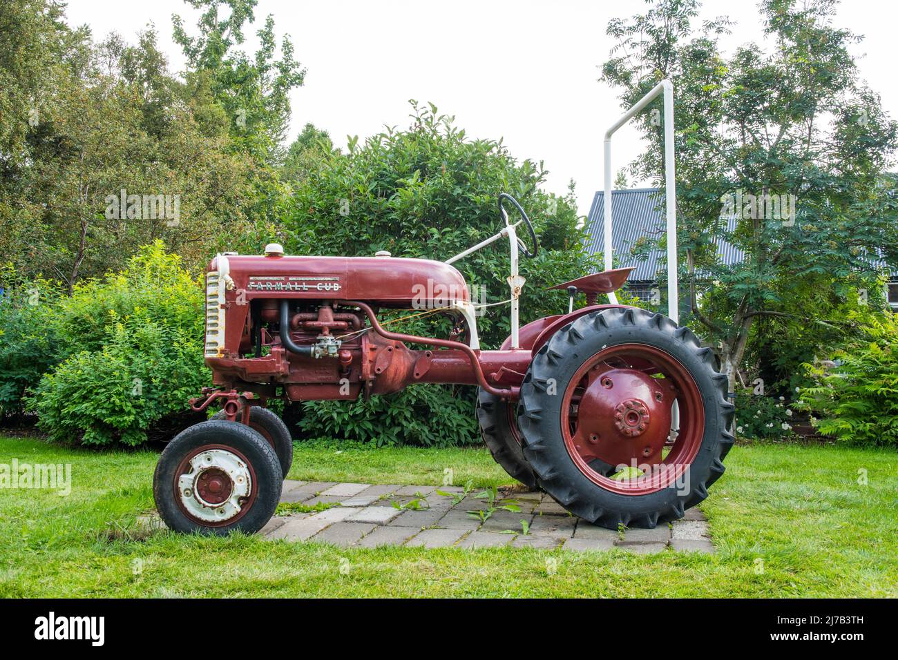 Akureyri, Iceland - August 4. 2021: Old Farmall Cup tractor in the botanical garden of Akureyri Stock Photo