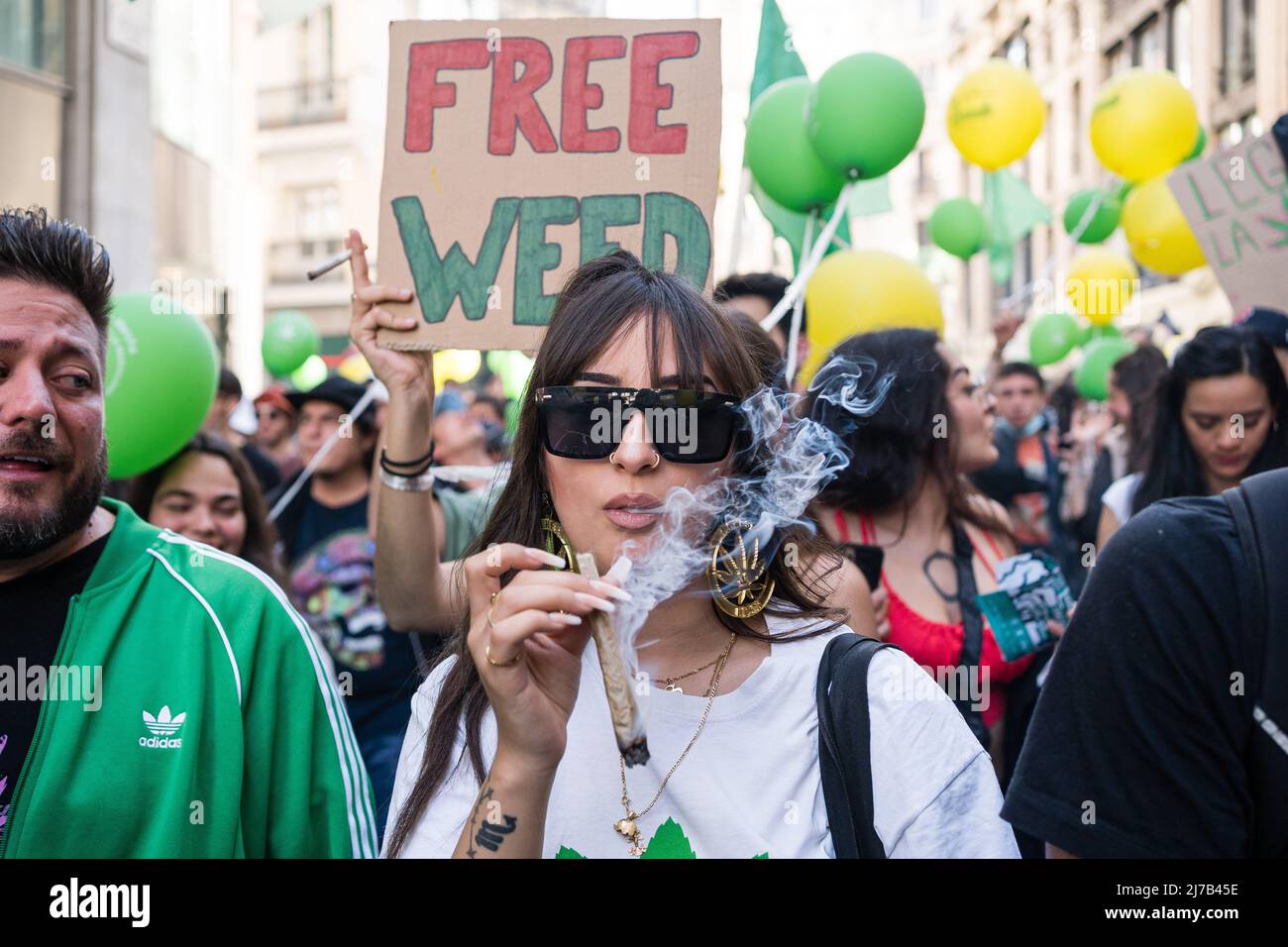 A pro-cannabis protester smokes a joint during a demonstration. Thousands of pro-cannabis activists took part in a demonstration in La Gran Via in Madrid, Spain, in favor of legalizing the medicinal and recreational use of marijuana. (Photo by Diego Radames / SOPA Images/Sipa USA) Stock Photo