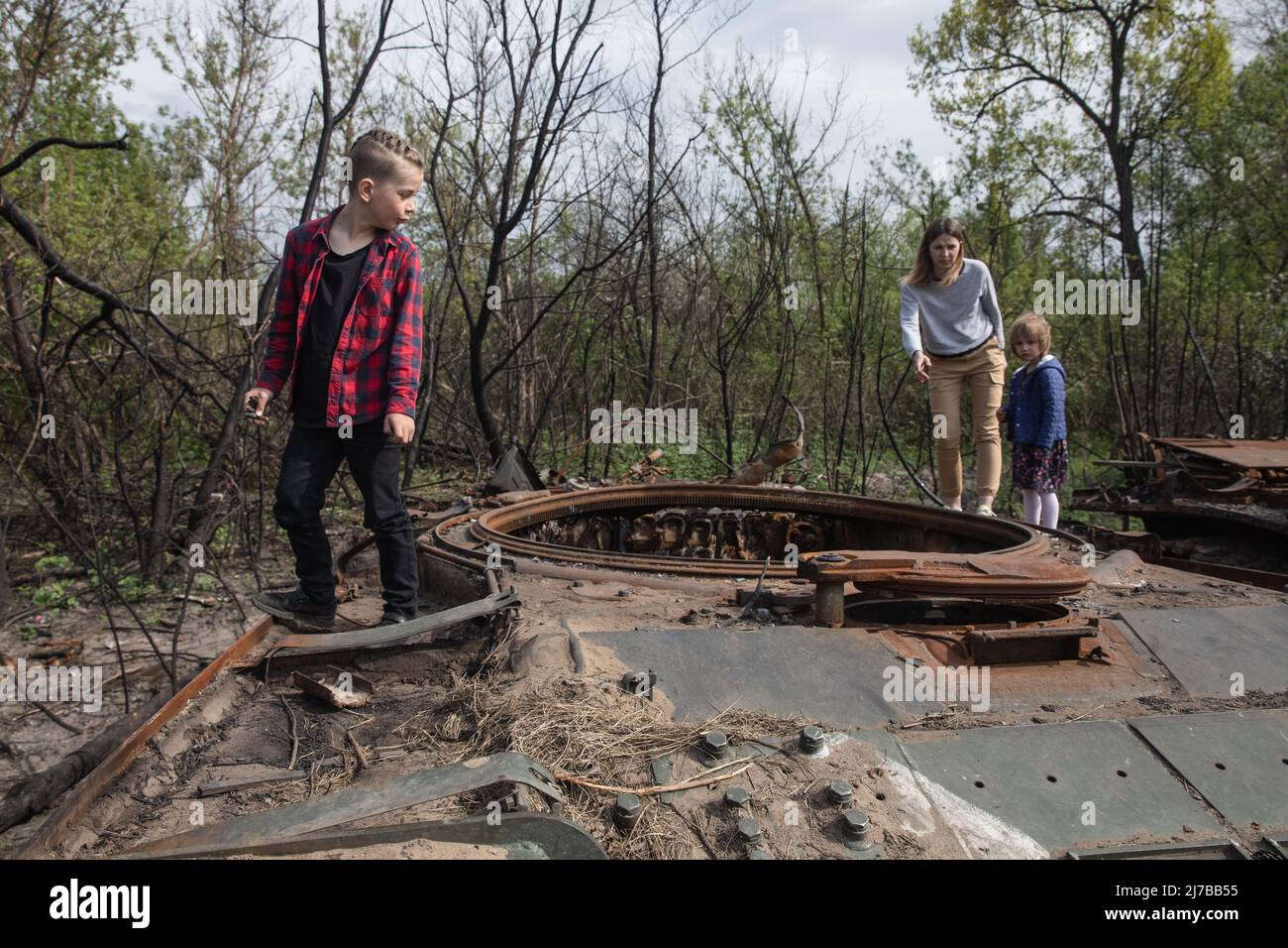 ?hildren stand on the tower of a destroyed Russian tank. Russia invaded Ukraine on 24 February 2022, triggering the largest military attack in Europe since World War II. Stock Photo