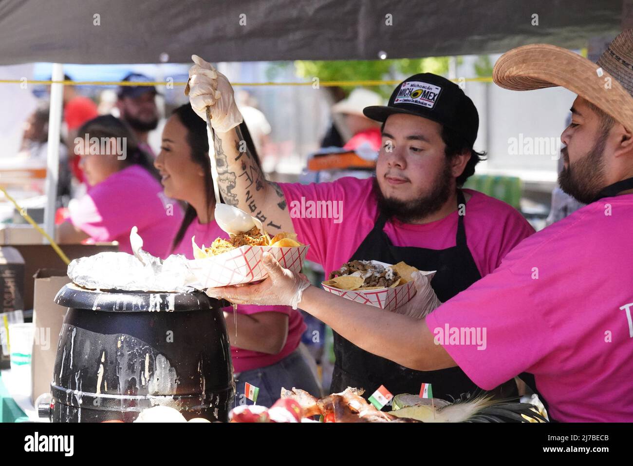 St. Louis, United States. 08th May, 2022. Sauces are applied to food at one of the many food stations at the Cinco de Mayo celebration in St. Louis on Saturday, May 7, 2022. Photo by Bill Greenblatt/UPI Credit: UPI/Alamy Live News Stock Photo