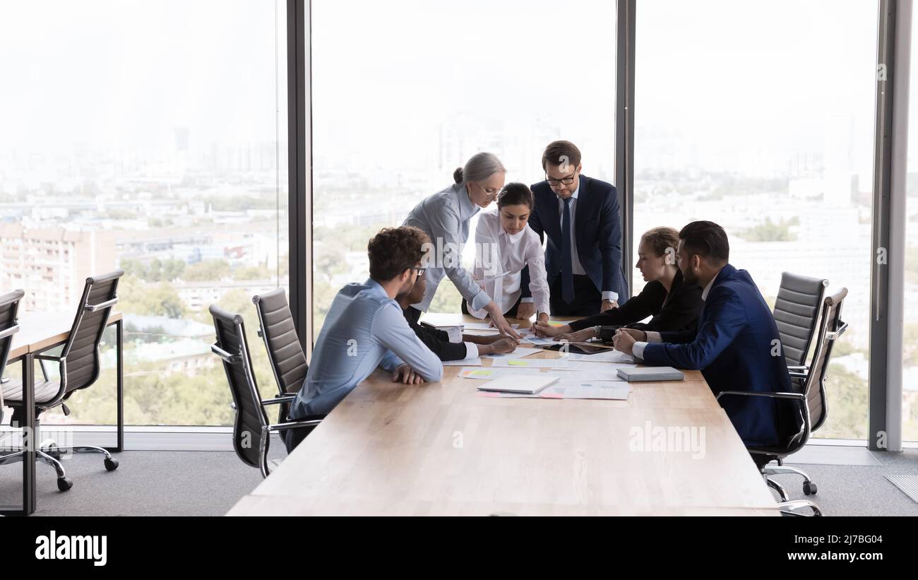 Team of interns and teacher studying marketing, working on startup Stock Photo