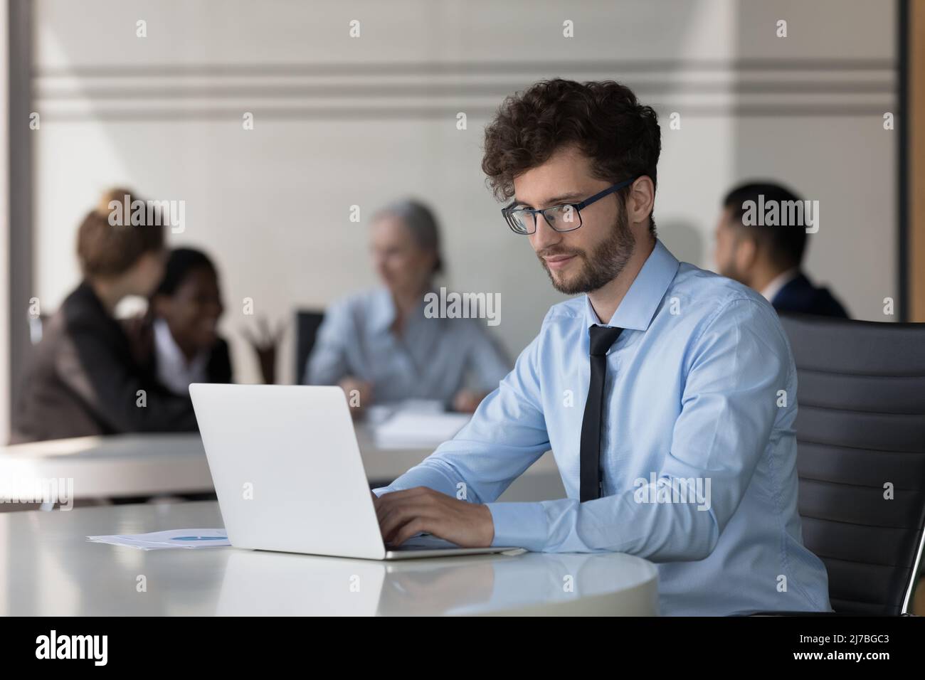 Serious young startup leader guy working on project Stock Photo