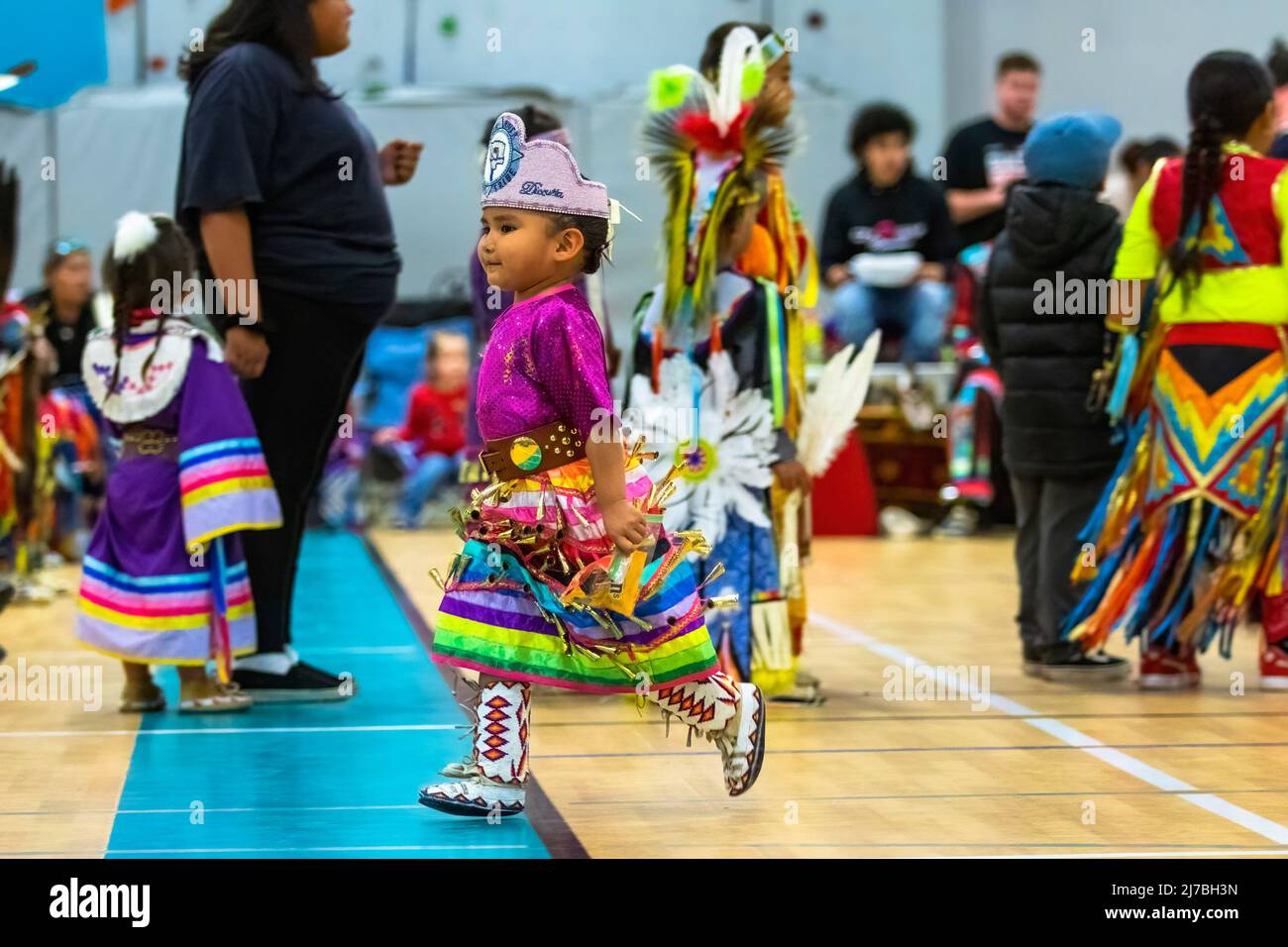 A young girl runs at a Powwow. The 1st Annual Red Dress Powwow was held ...