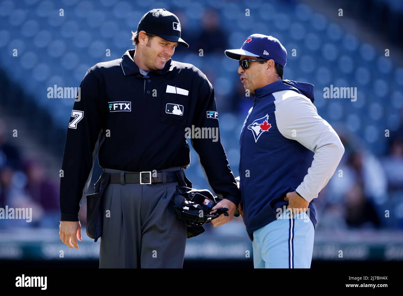 CLEVELAND OH MAY 7 Toronto Blue Jays manager Charlie Montoyo 25 jokes with home plate umpire Ryan Additon 67 during a game against the Cleveland Guardians at Progressive Field on May
