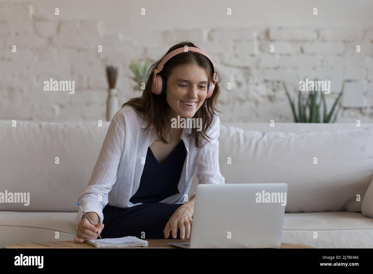 Happy focused gen Z student girl in big wireless headset Stock Photo ...