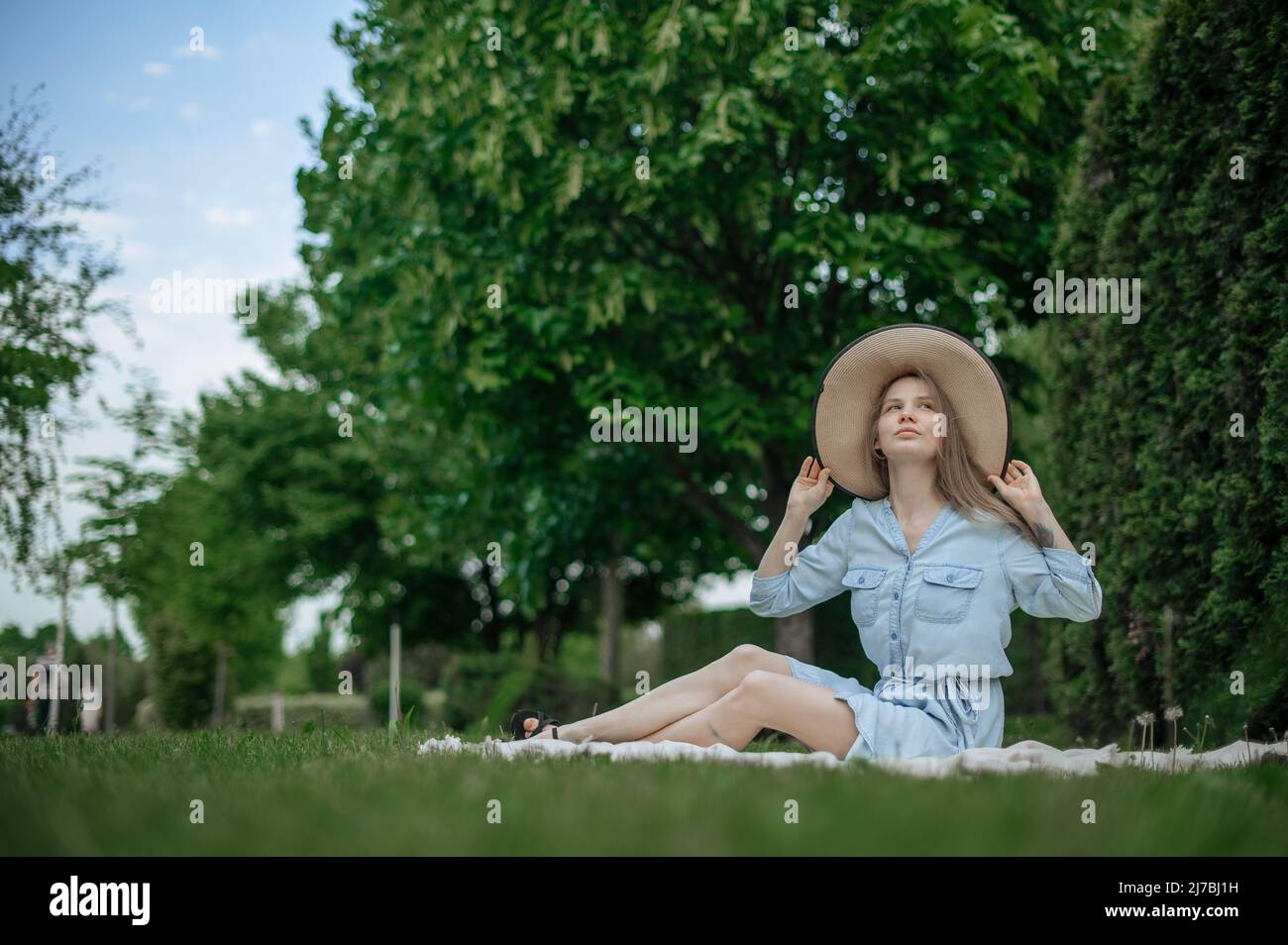 Romantic girl with hat on picnic in park Stock Photo Alamy