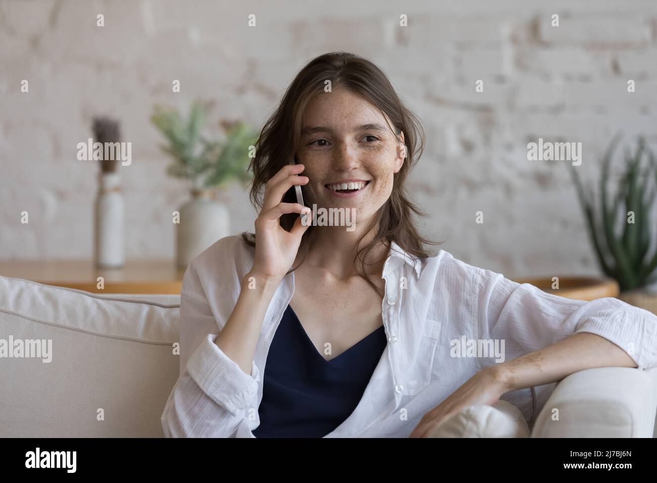 Cheerful engaged mobile phone user girl enjoying telephone talk Stock Photo