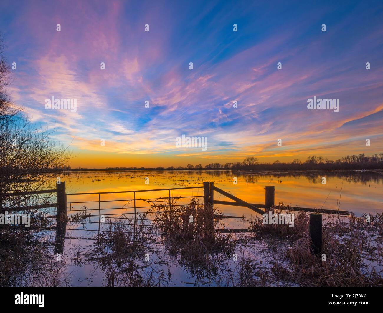 Dramatic evening sky after sunset above the Ouse Washes in winter flood, Sutton Gault, Cambridgeshire Stock Photo