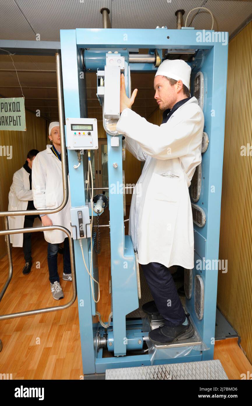 Man in a white protective clothes passing through a radiological
