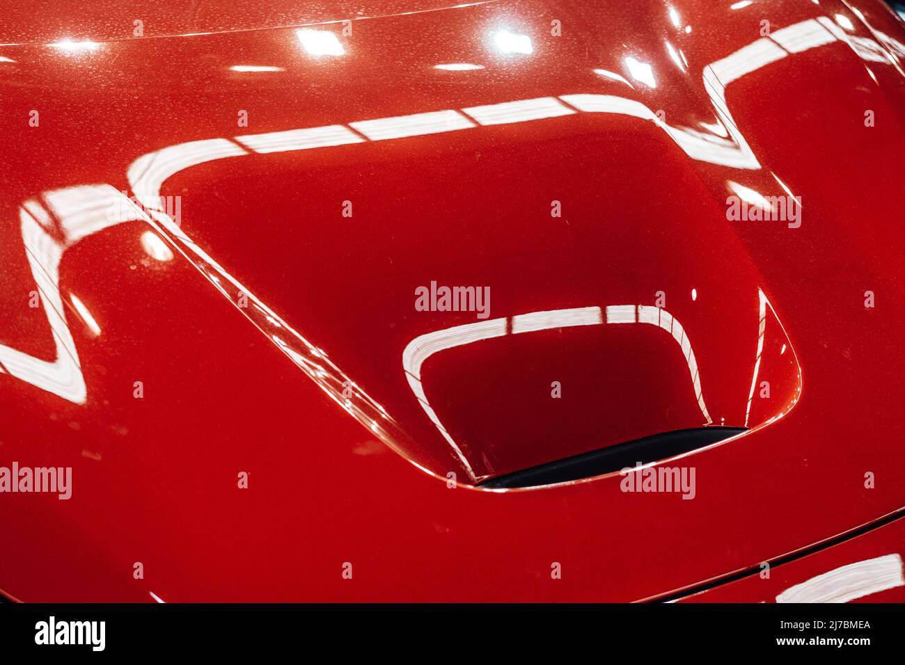 Detail of an exhaust hole on the hood of a red sports car Stock Photo Alamy
