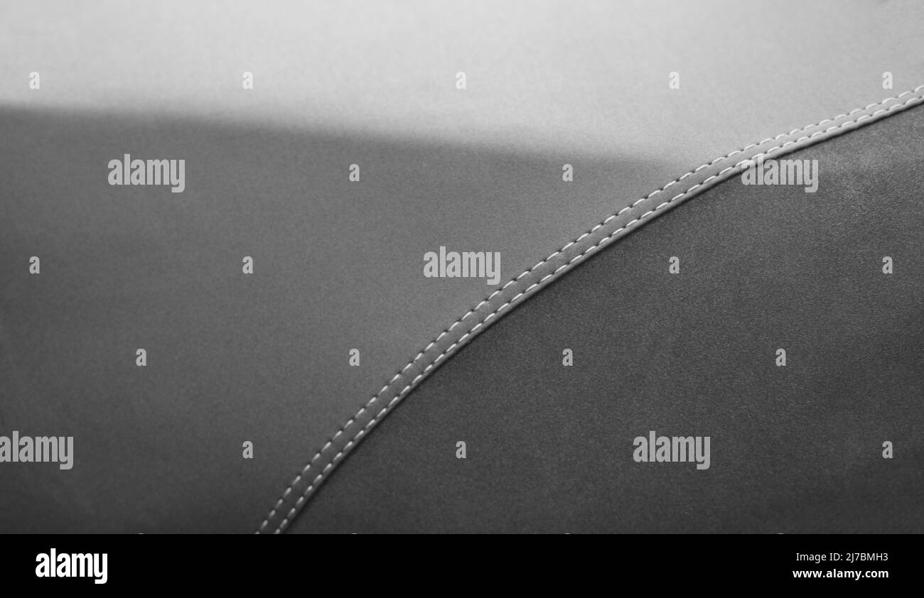 Detail of grey leather texture with a stitching in form of a curve Stock Photo
