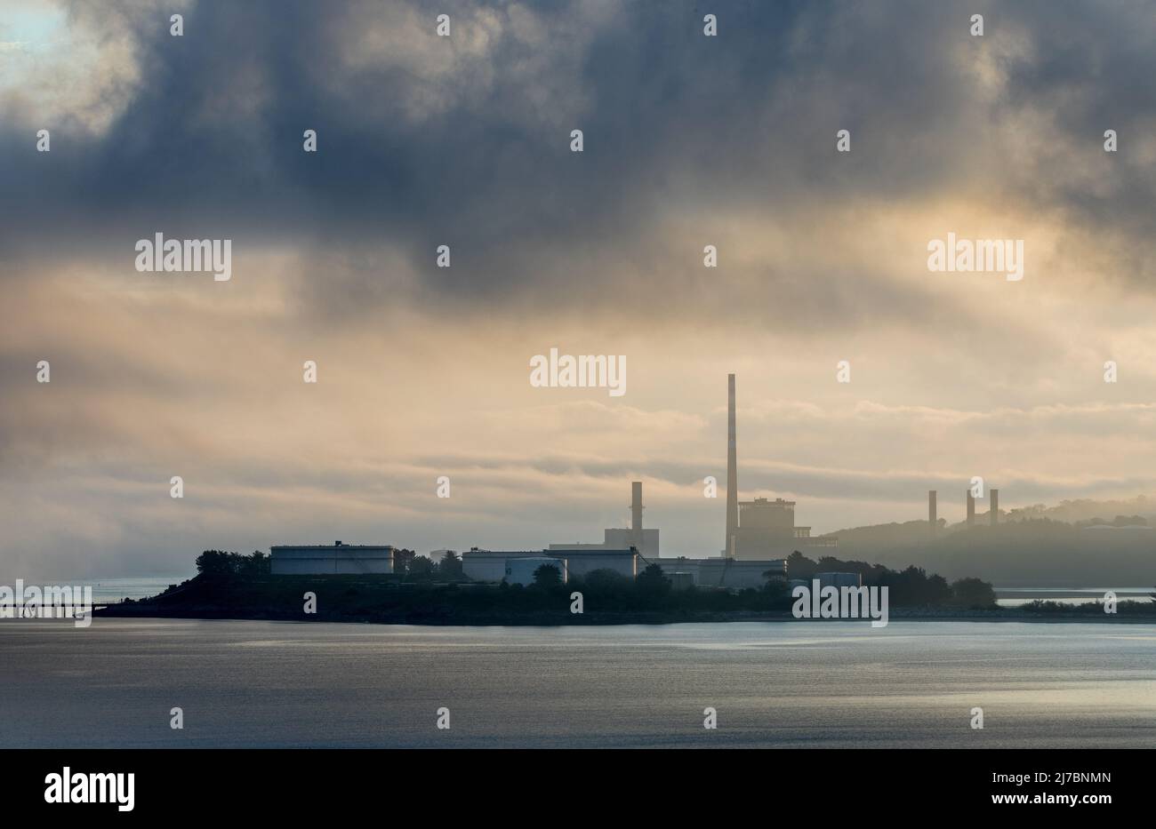 Whitegate, Cork, Ireland. 08th May, 2022. Morning fog begins to shroud the generating station and oil storage tanks in Whitegate, Co. Cork, Ireland. - Credit; David Creedon / Alamy Live News Stock Photo