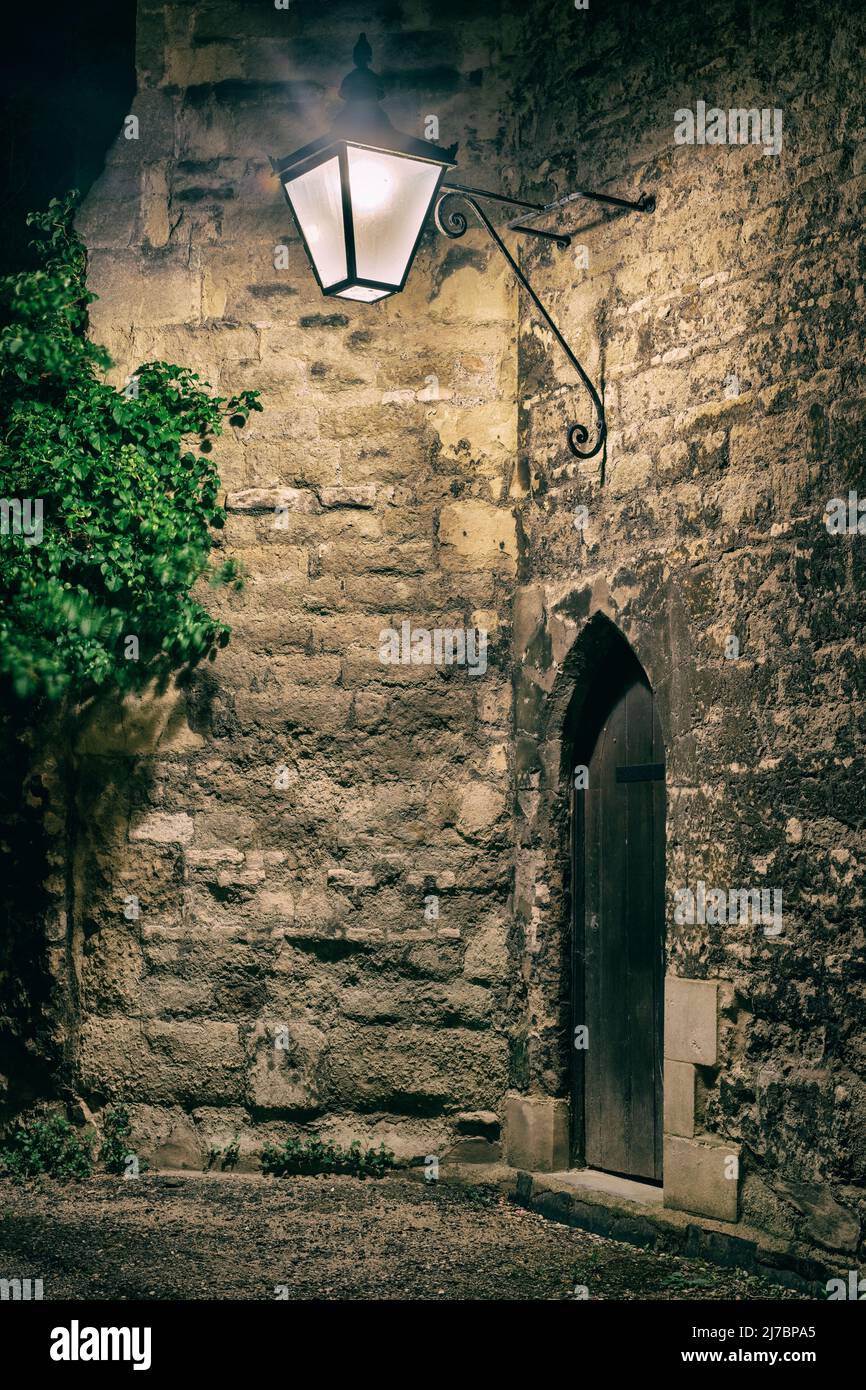 Arched door and street lamp. Queens Lane, Oxford, Oxfordshire, England Stock Photo