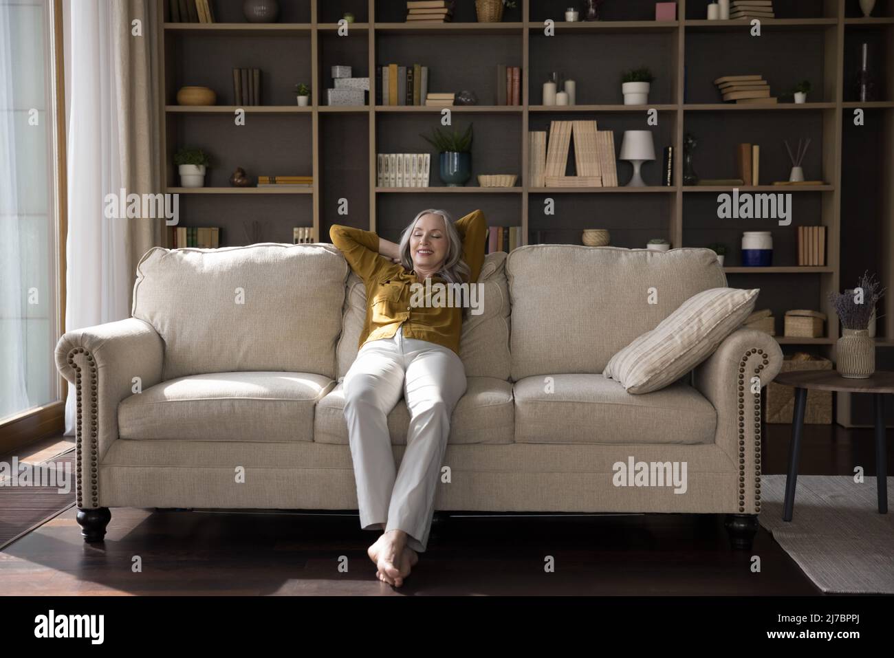 Old woman sitting alone sofa hi-res stock photography and images - Alamy